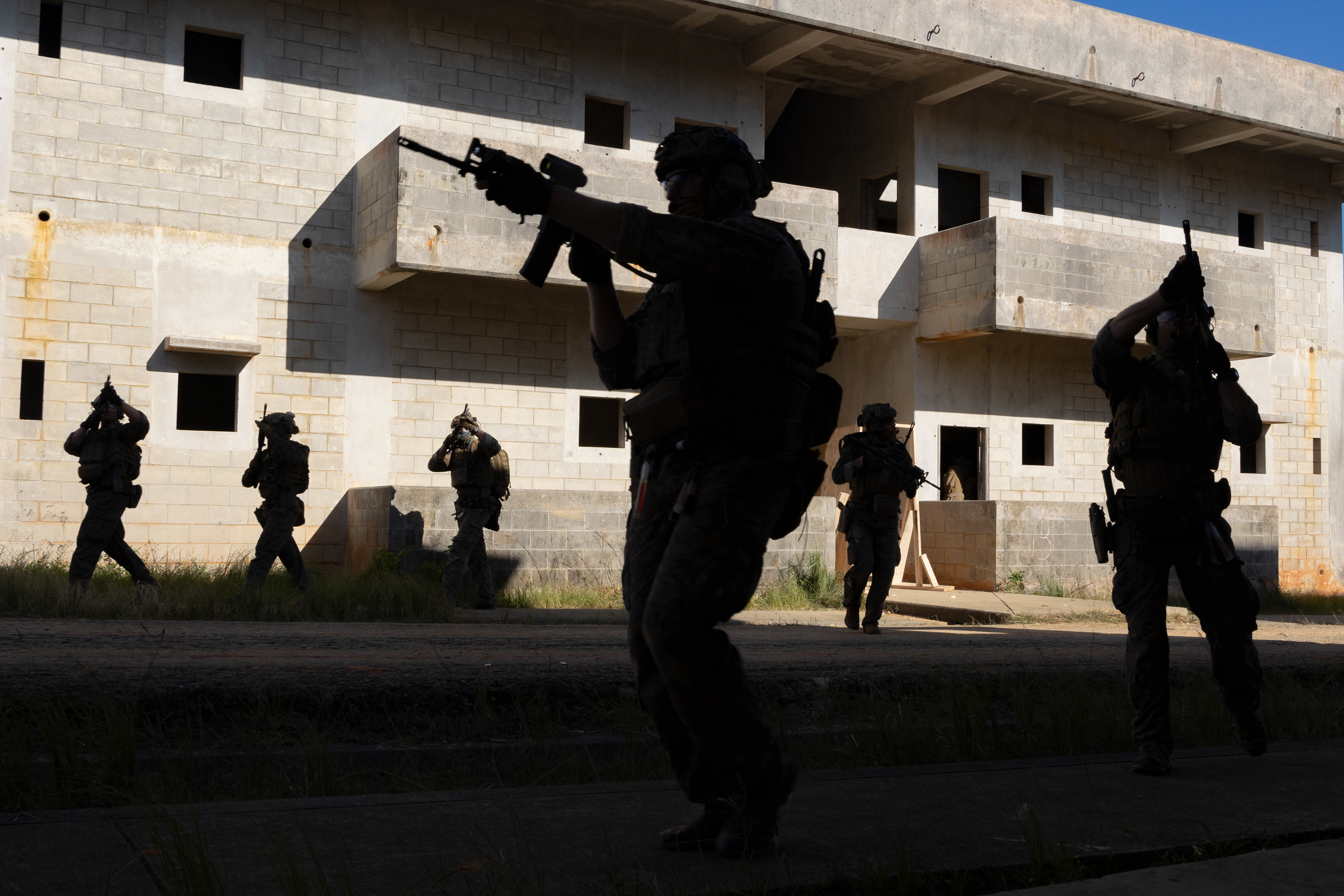 U.S. Marines with the maritime raid force, 31st Marine Expeditionary Unit, advance their position during a simulated raid on Combat Town at Camp Hansen on Nov. 16, 2023 in Okinawa, Japan.