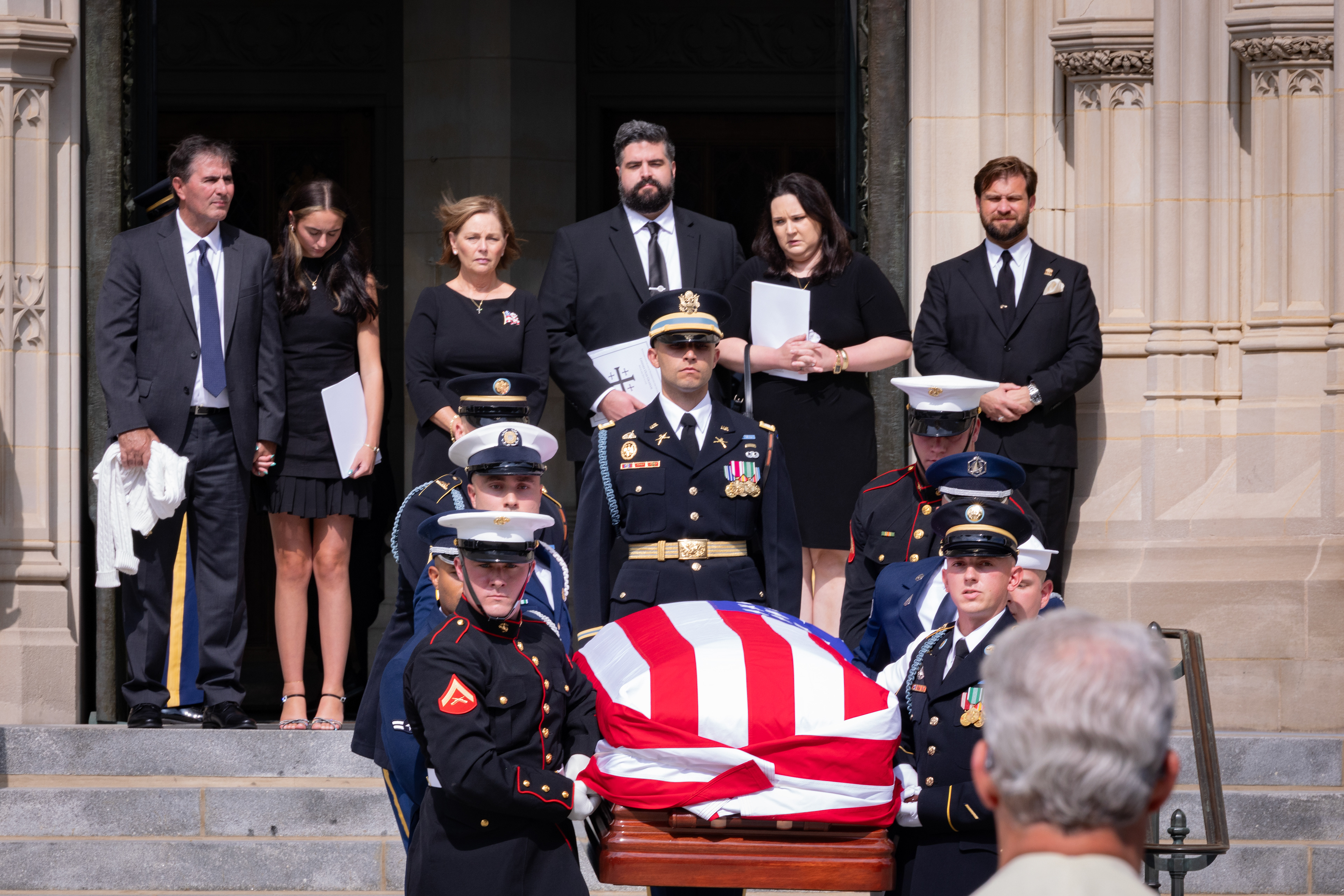 U.S. Sen. Darling Graham Nordone (R-SC), back-center, stands with her family as a military body bearer team carries the casket of the late U.S. Sen. Lindsey O. Graham (R-SC) outside the Washington National Cathedral on July 28, 2026 in Washington, D.C. (Photo by Tyler M. Andrews/The Washington Post)