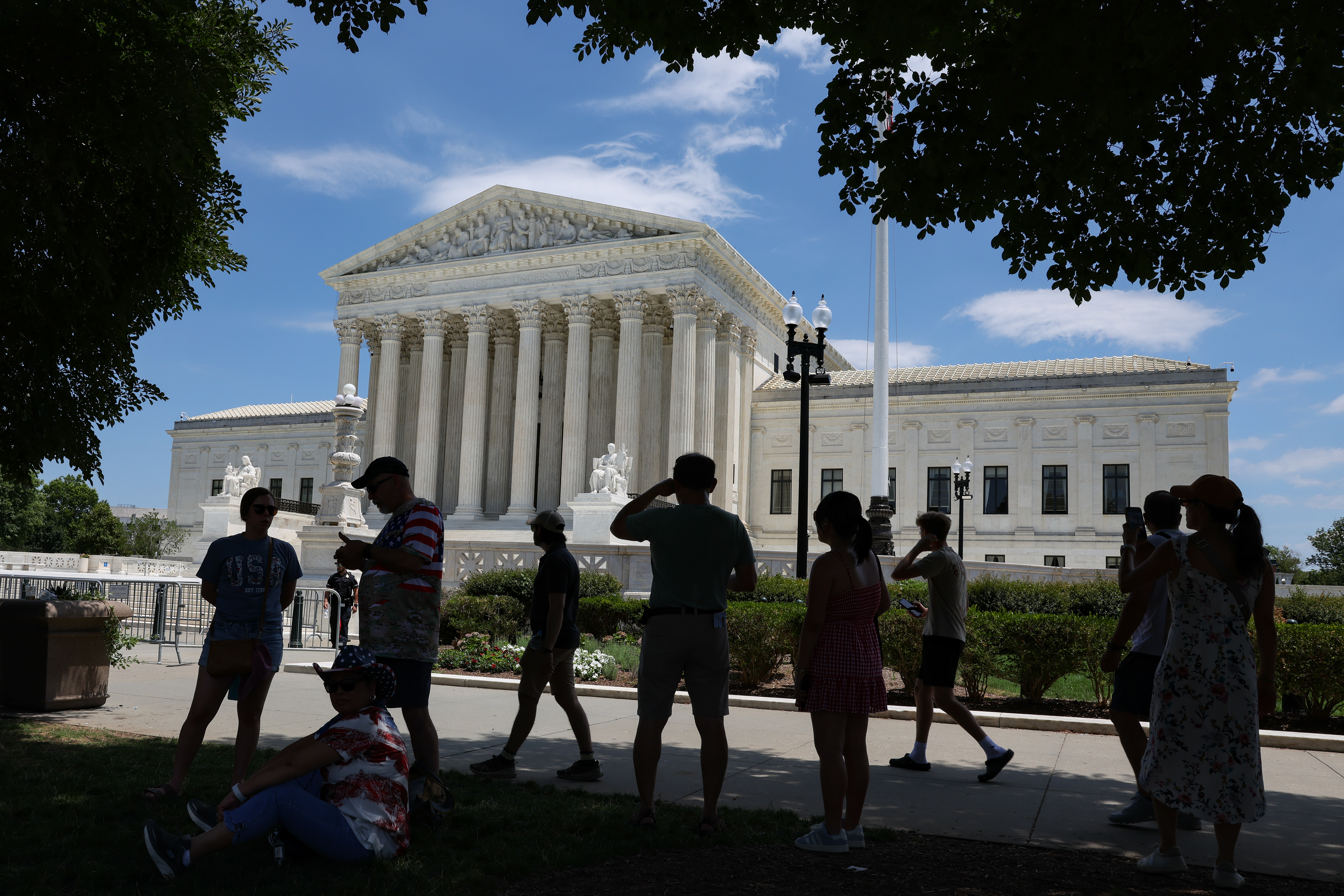 Visitors stand in the shade outside of the Supreme Court of the United States on July 4, 2026 in Washington, D.C. (Photo by Tyler M. Andrews/The Washington Post)