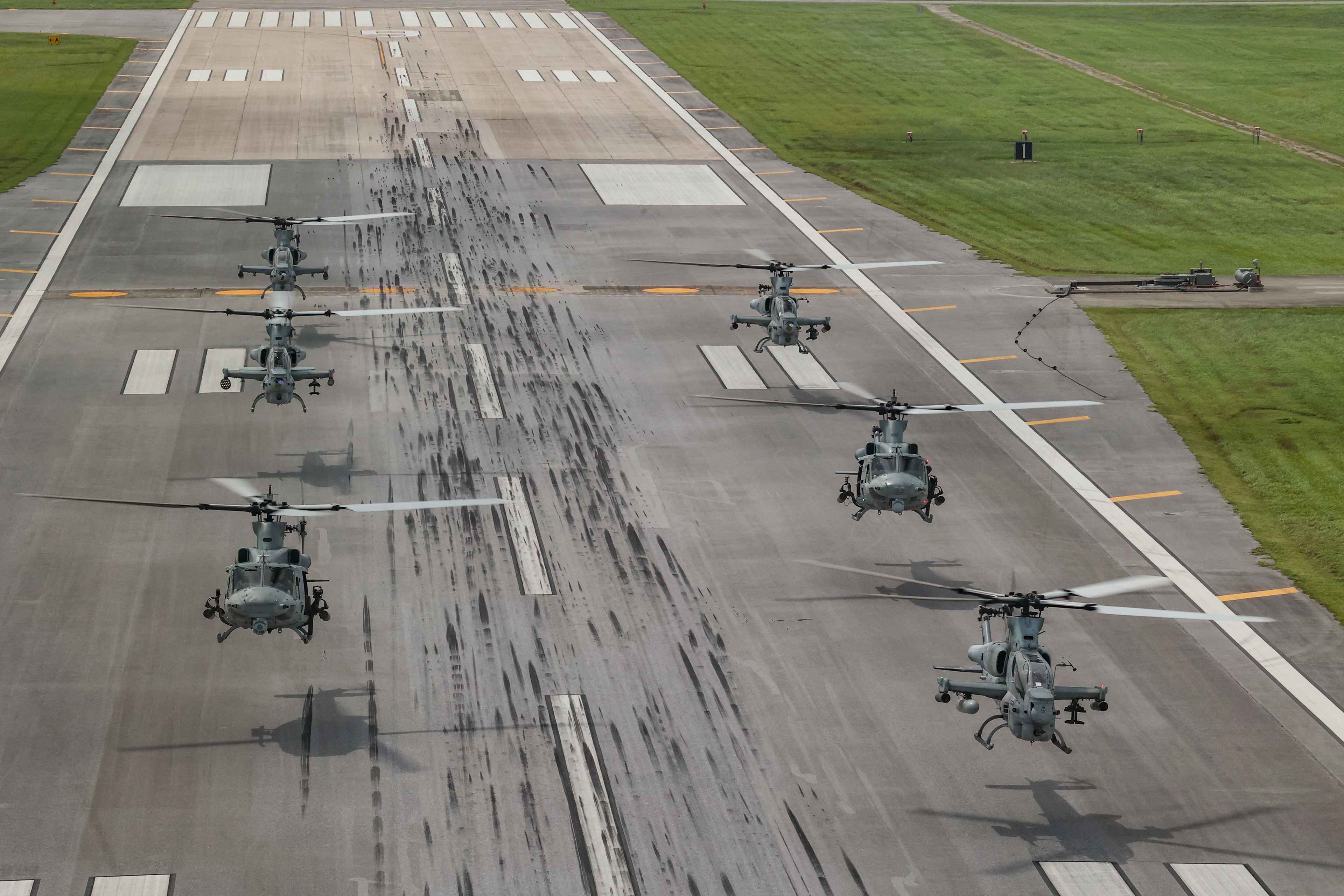 U.S. Marine Corps UH-1Y Venom helicopters and AH-1Z Viper attack helicopters with Marine Light Attack Helicopter Squadron 169, deployed to 1st Marine Aircraft Wing, III Marine Expeditionary Force, take flight for unit training at Marine Corps Air Station Futenma on Oct. 3, 2023 in Okinawa, Japan.
