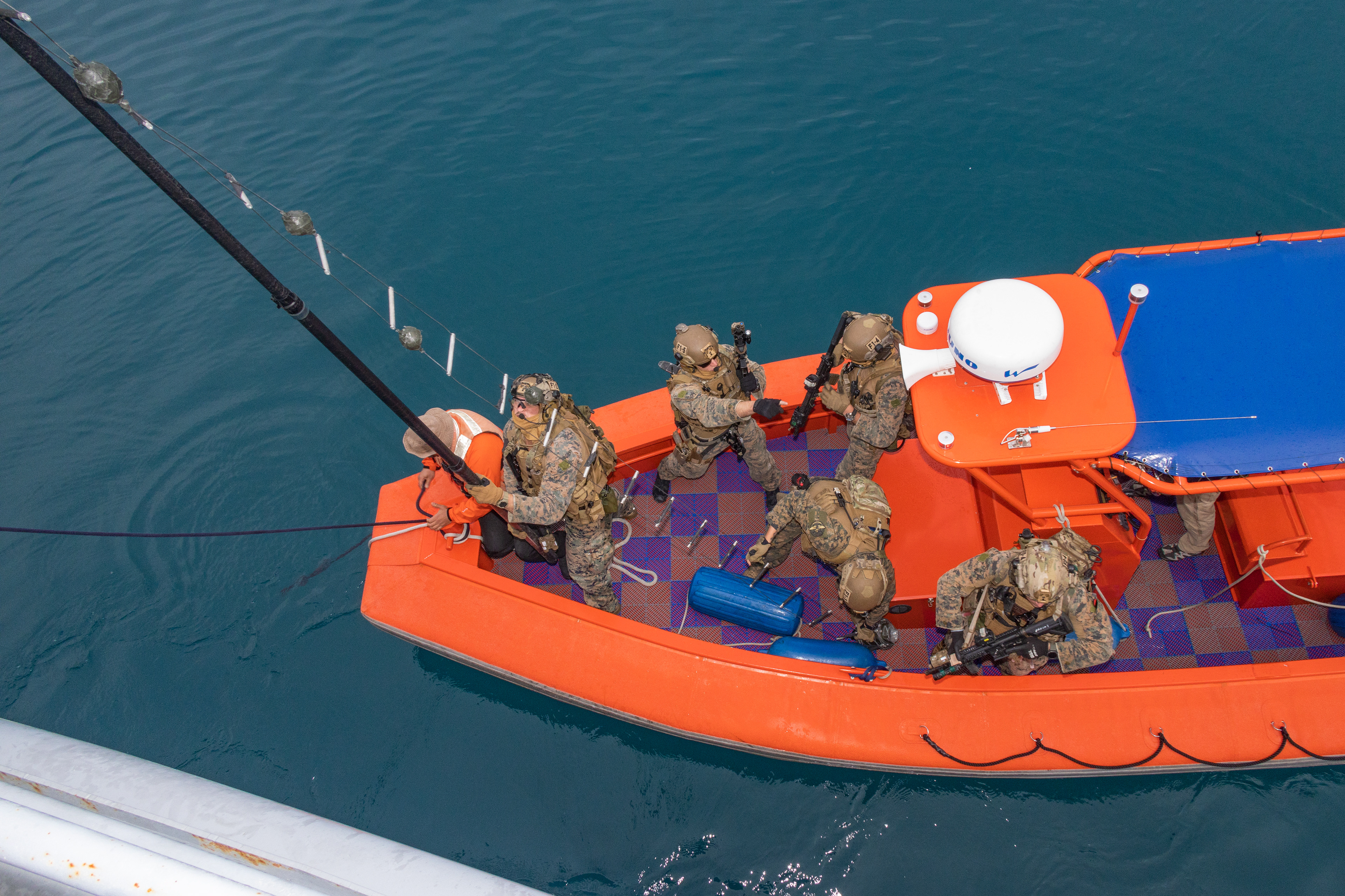 U.S. Marines with the maritime raid force, 31st Marine Expeditionary Unit, prepare to board U.S. Army landing craft, USAV Calaboza (LCU 2009) during a visit, board, search, and seizure training at White Beach Naval Facility on Dec. 6, 2023 in Okinawa, Japan.