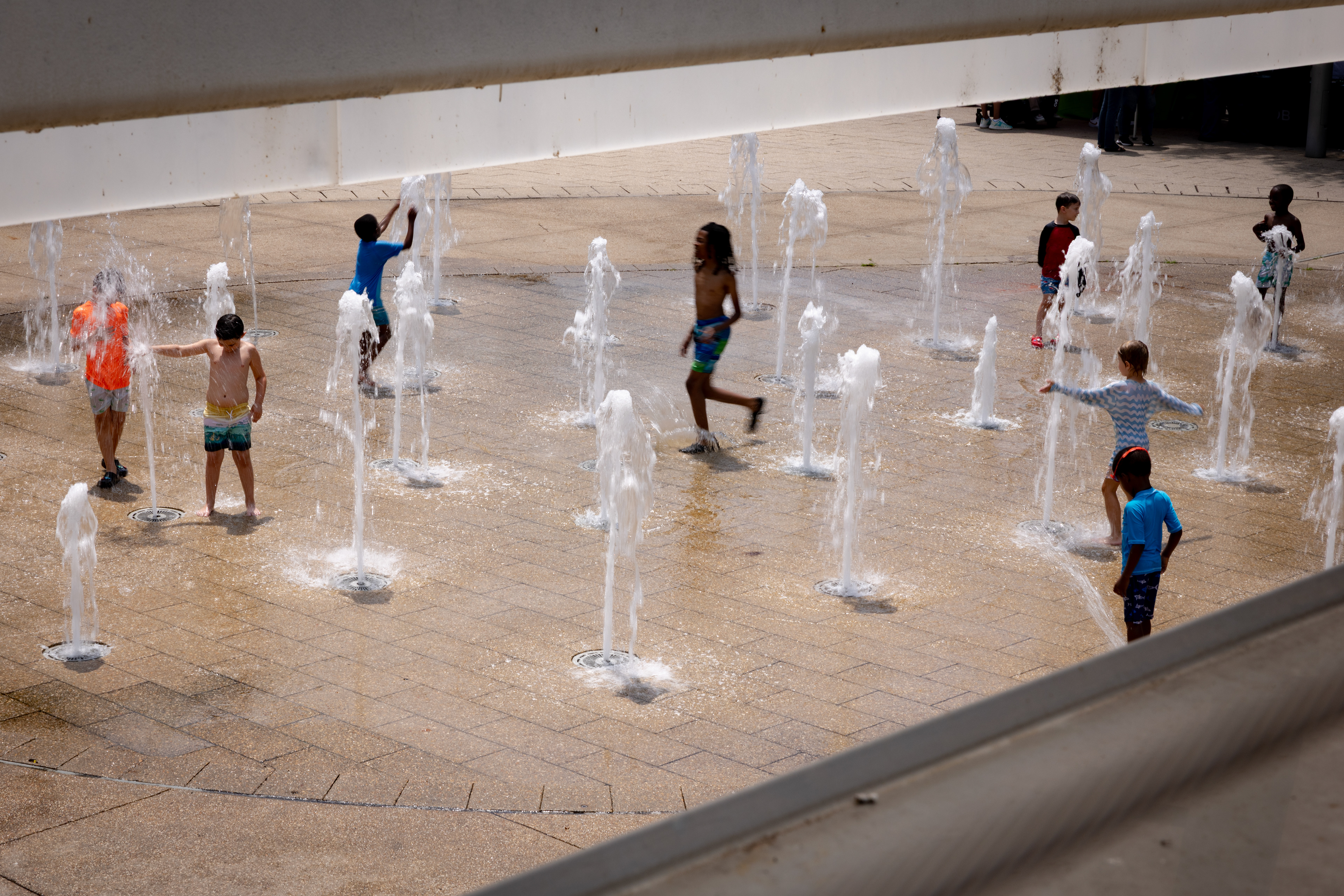 Youth cool off in the M Street Water Park at Canal Park on July 9, 2026 in Washington, D.C. (Photo by Tyler M. Andrews/The Washington Post)