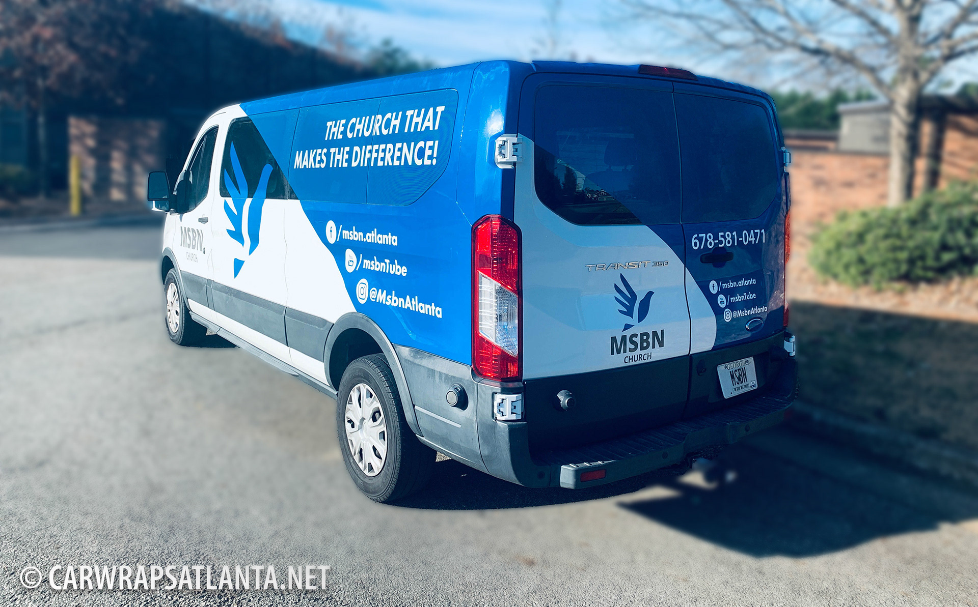 Close-up of faith and community messaging graphics on the Ford Transit partial wrap.