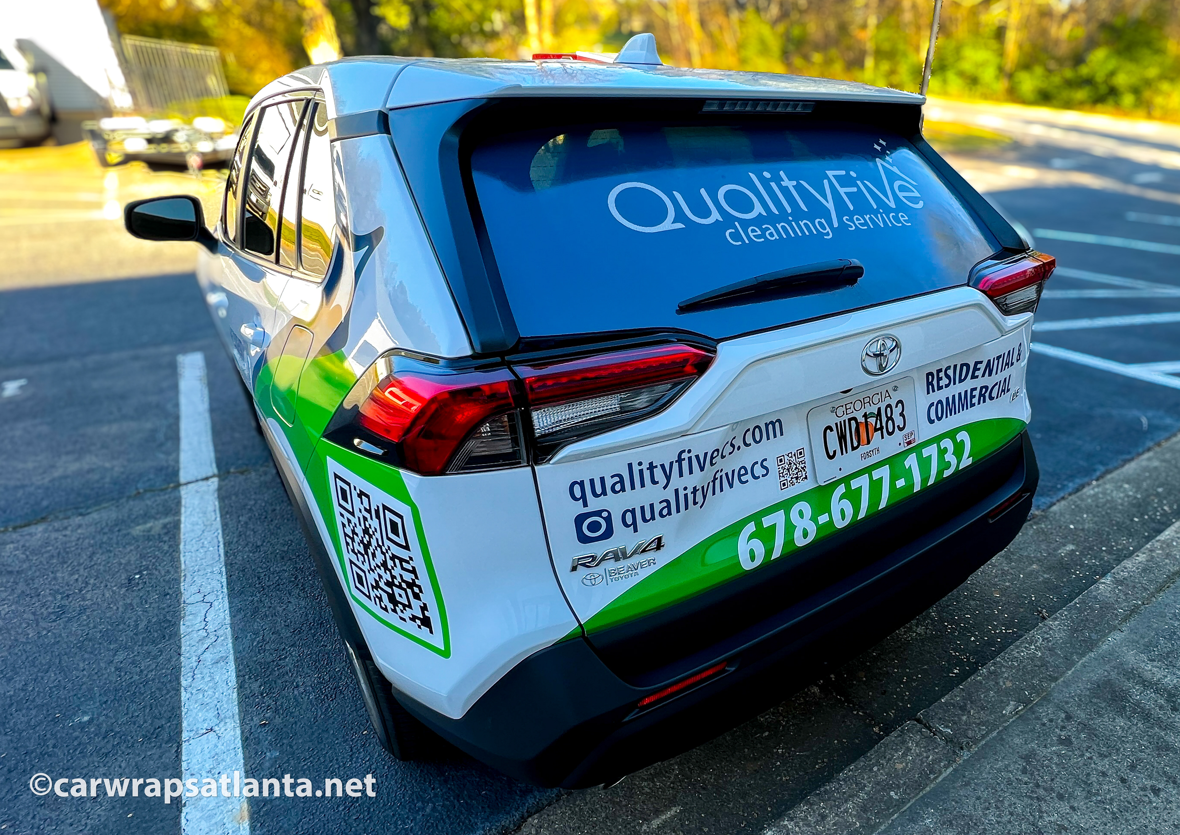 Rear view of the Toyota RAV4 spot graphics showcasing cleaning service contact information and professional branding in Atlanta.