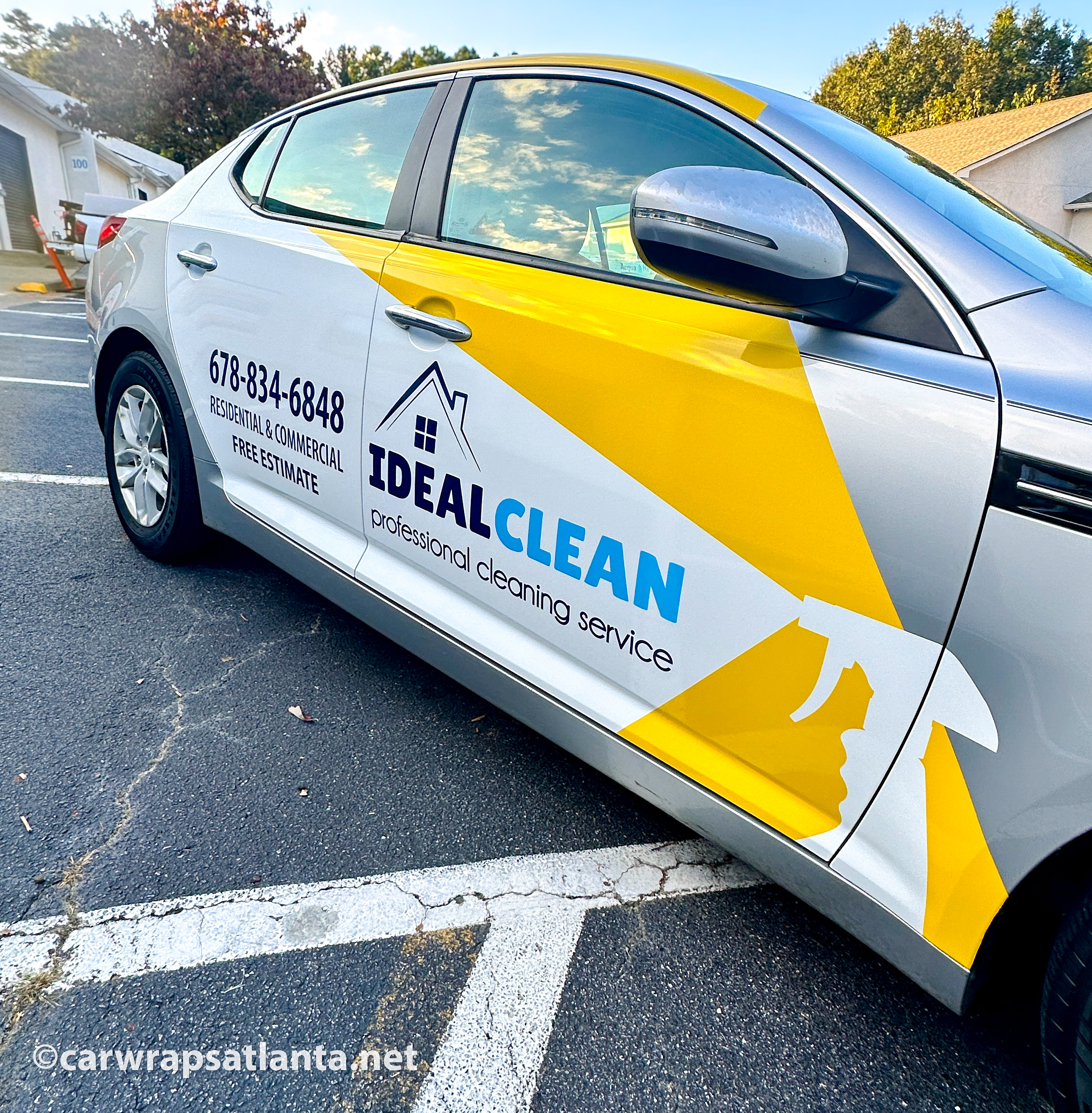 Kia Optima with spot graphics parked in a residential area, highlighting local visibility in Kennesaw, GA.