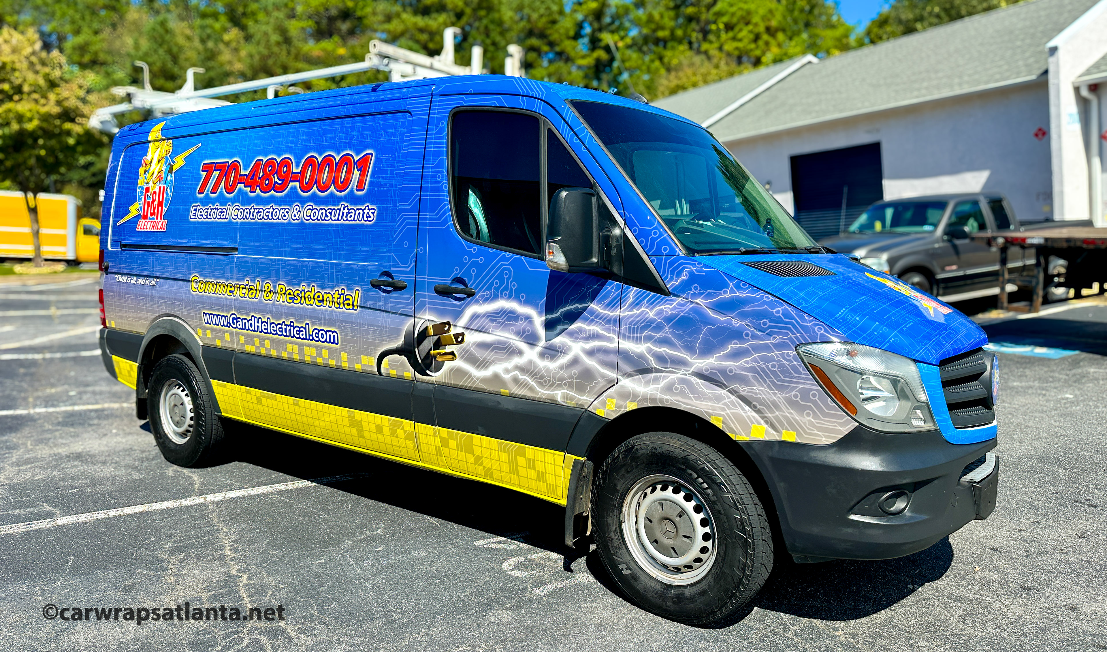 Close-up of high-contrast logo and service details on the full Mercedes-Benz Sprinter wrap.