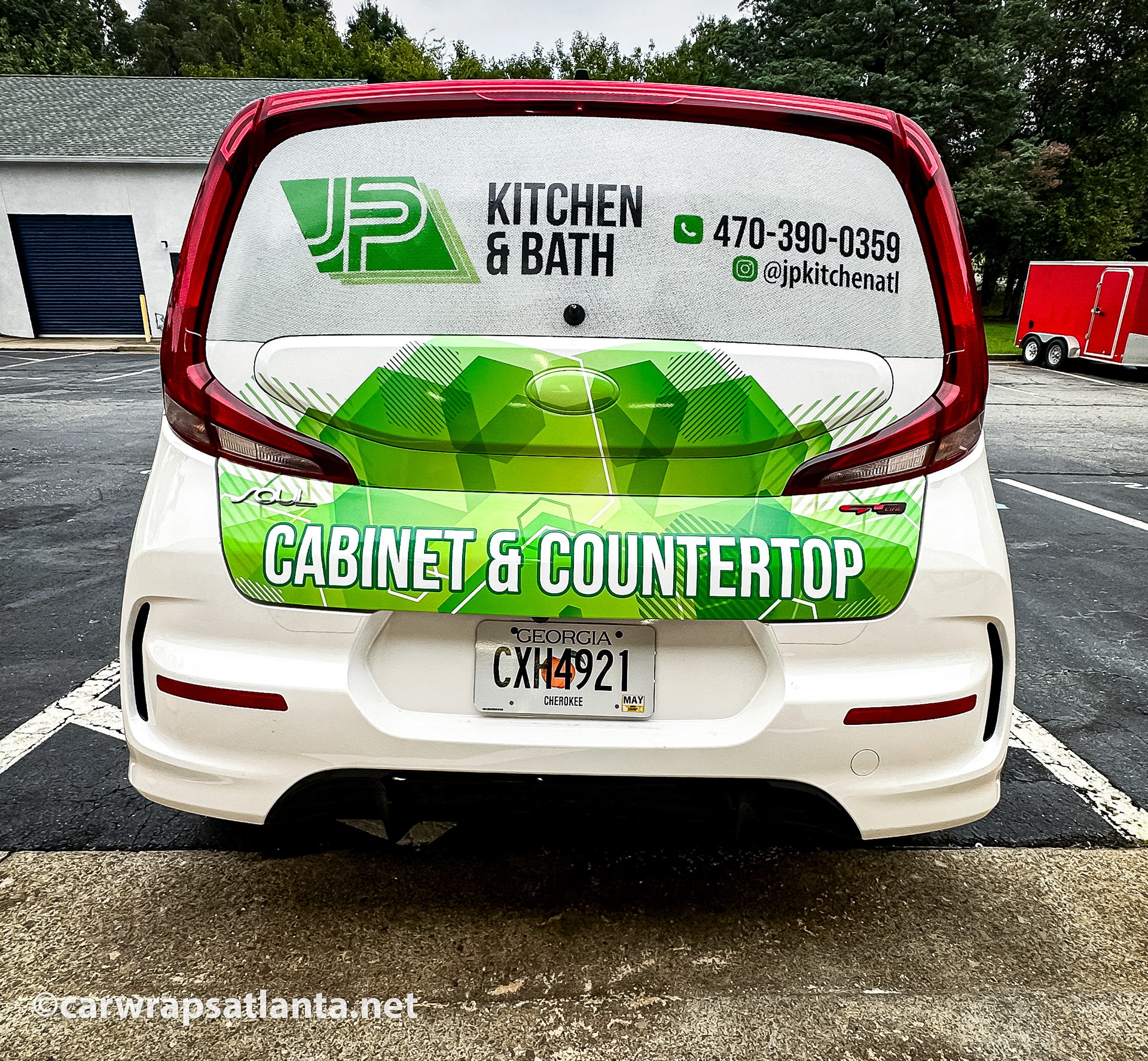 Rear view of the Kia Soul with partial wrap demonstrating effective advertising in the Woodstock area.