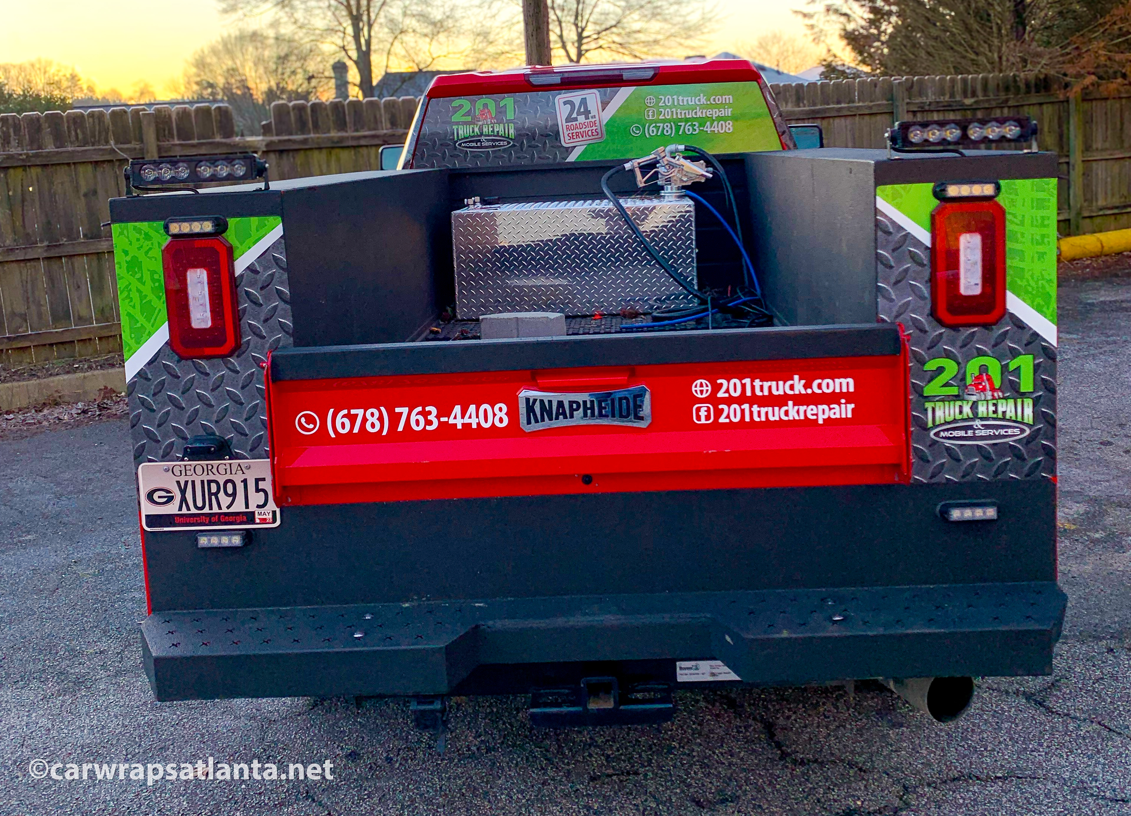 Rear panel graphics on thRear panel graphics on the truck partial wrap showcasing repair service contact information in Atlanta.