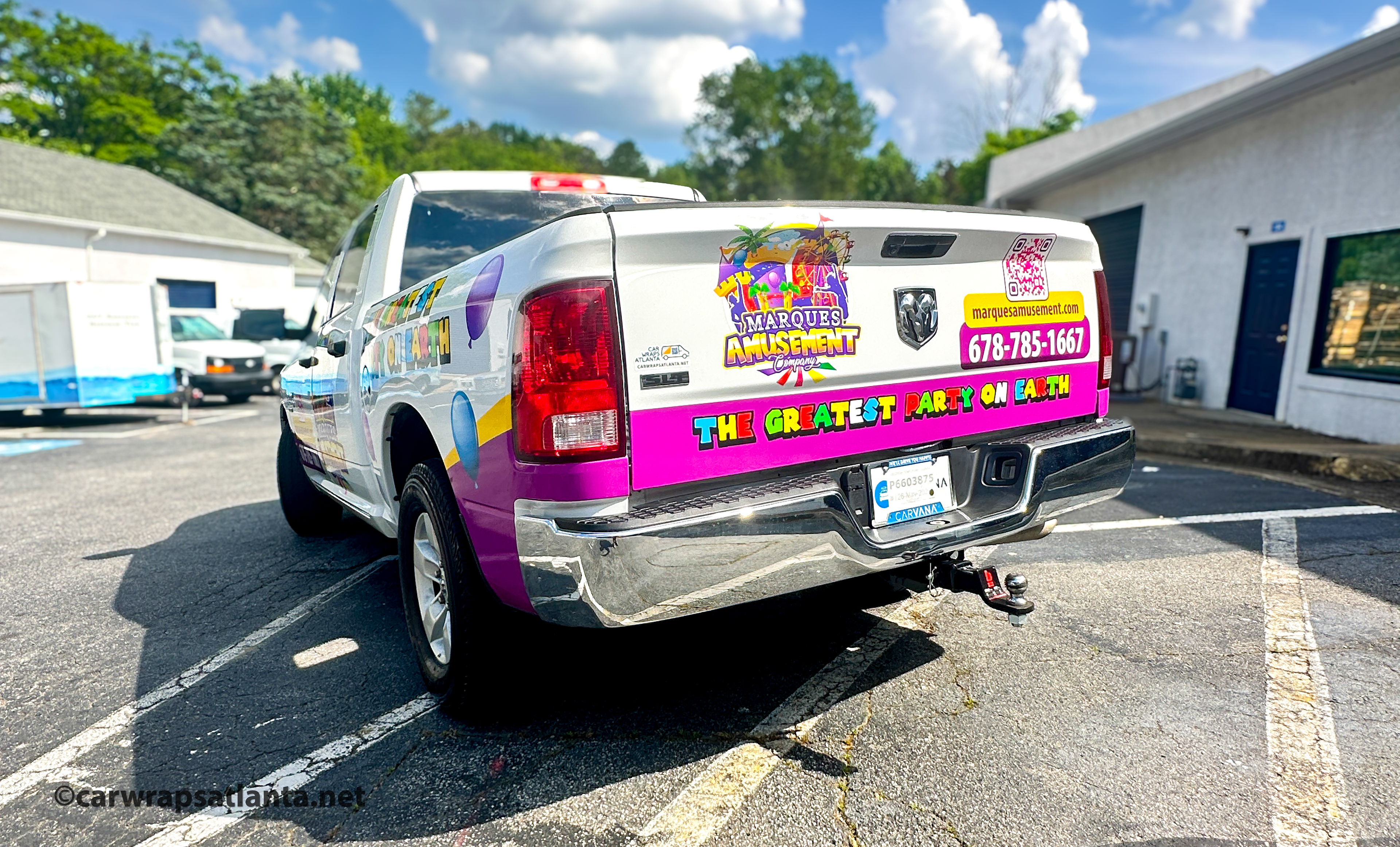 Alt Text: In-progress photo showing the professional installation process of the full wrap on the event rental truck.