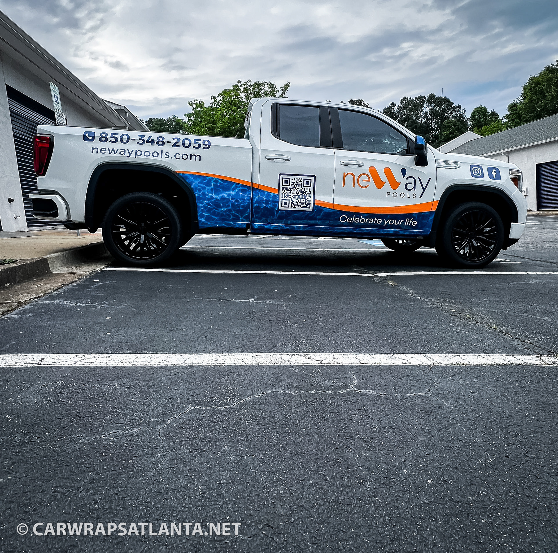 Side view of the Neway Pools partial GMC truck wrap, showcasing the brand's logo and colors.