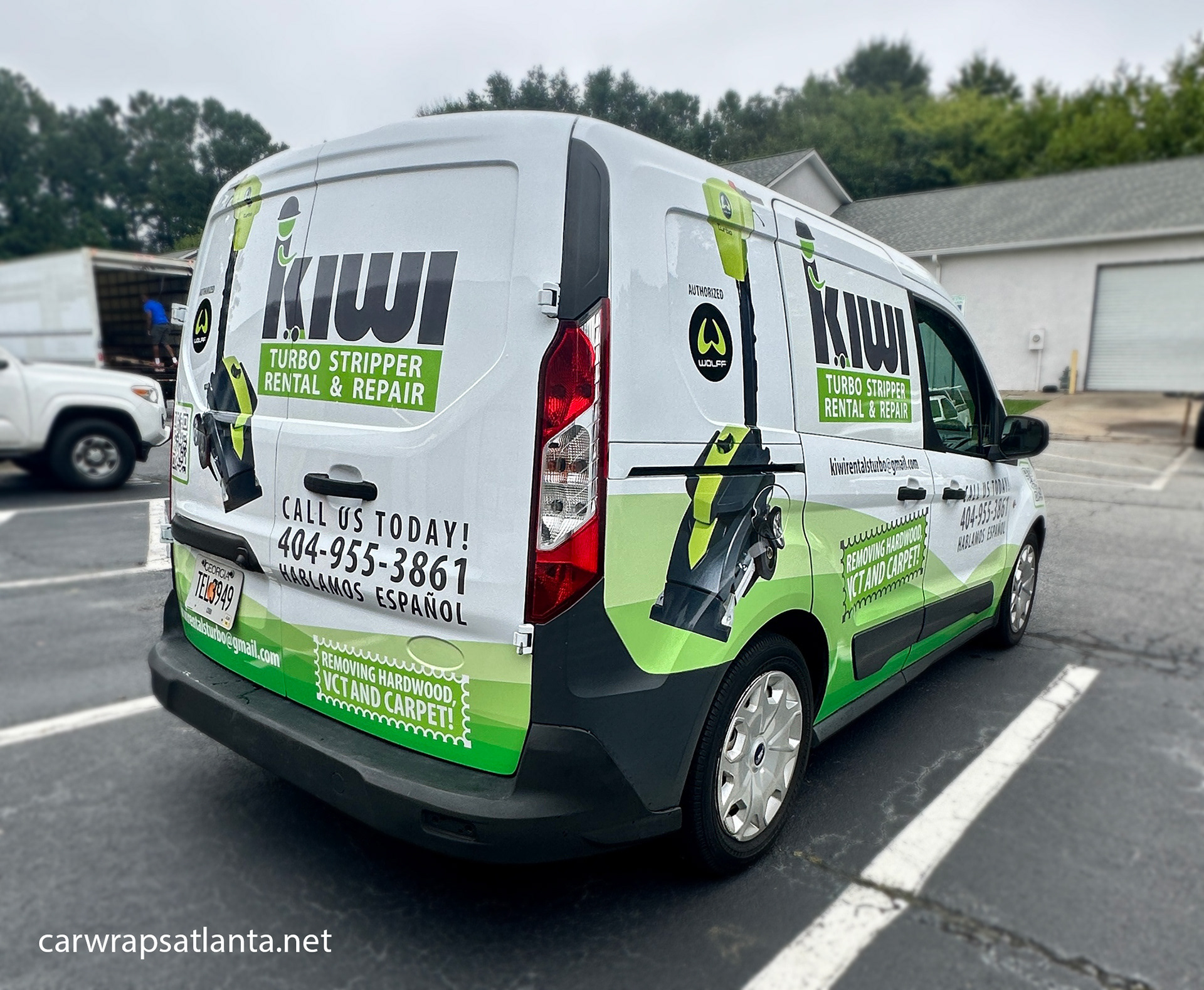 Professional installation detail showing seamless application of the partial wrap on the Ford Transit Connect.