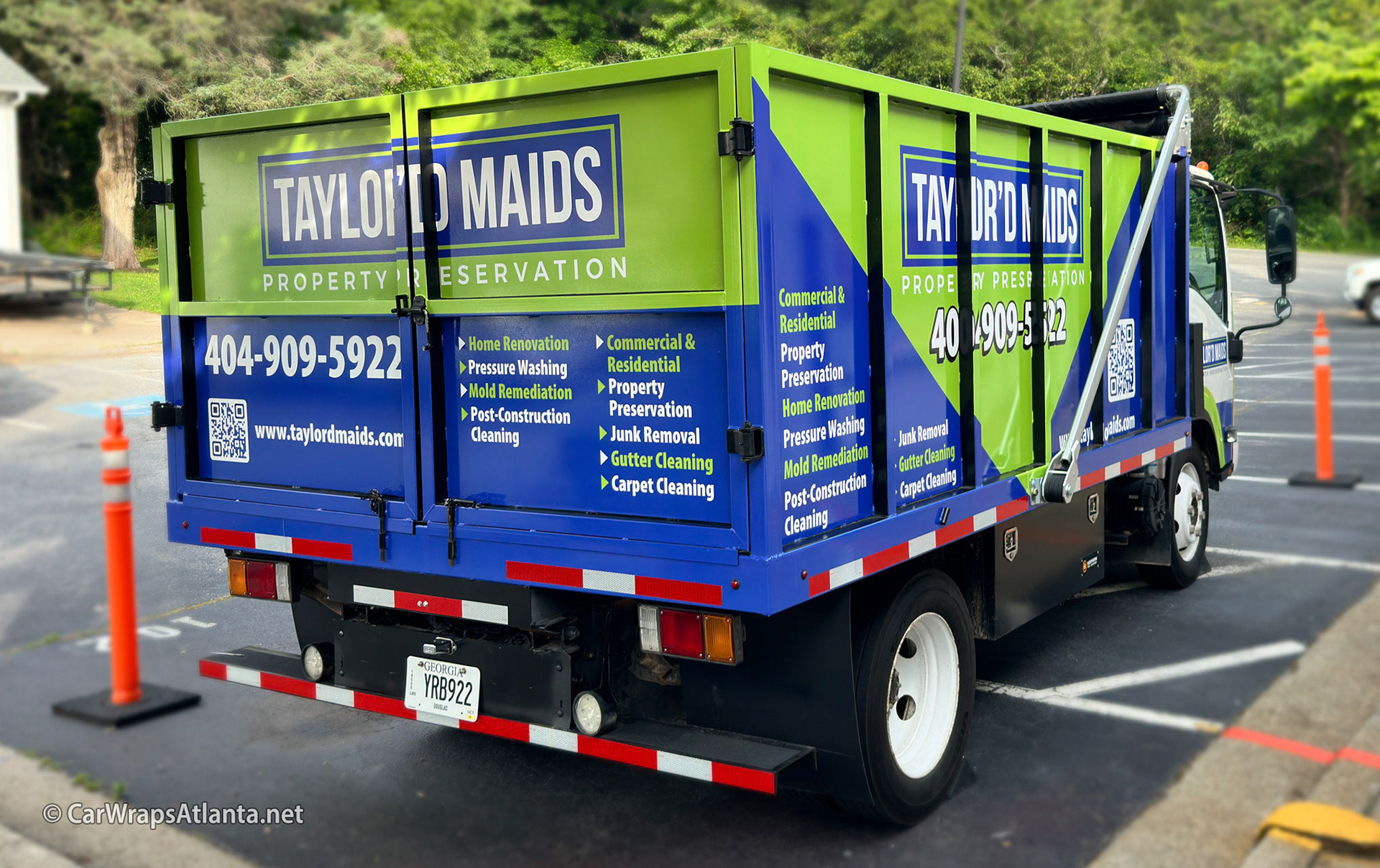 Full view of the wrapped dump trailer, highlighting its massive advertising canvas in the Atlanta metro area.