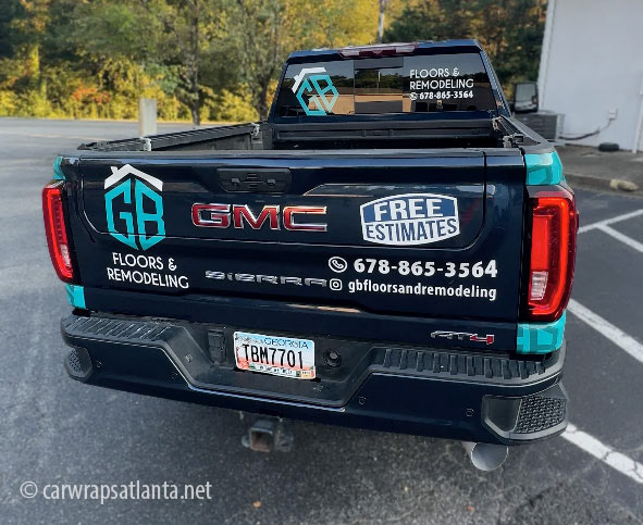Full view of the wrapped GMC Sierra and trailer demonstrating cohesive fleet branding.