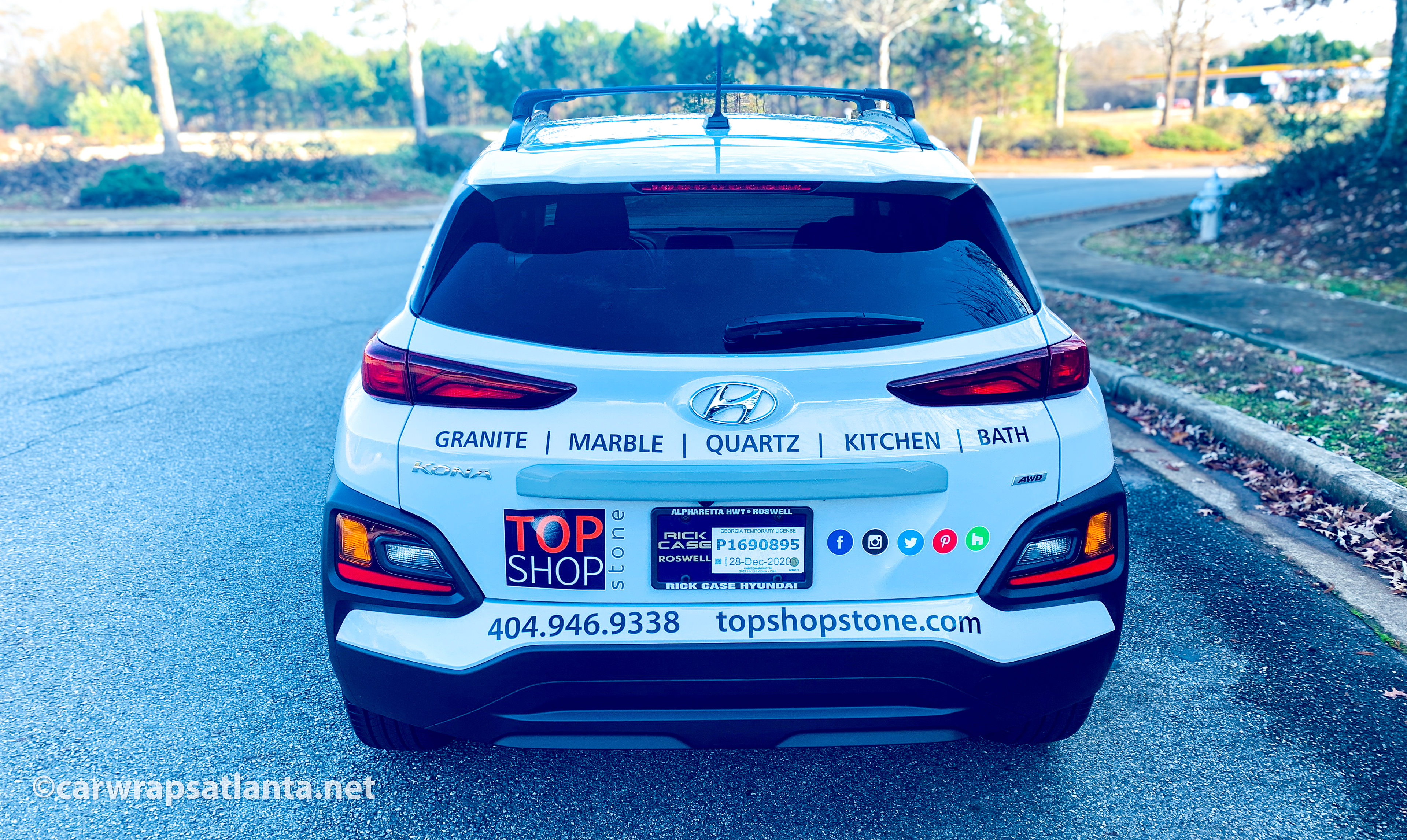 Hyundai Kona with spot graphics parked in a commercial setting in the Atlanta metro area.