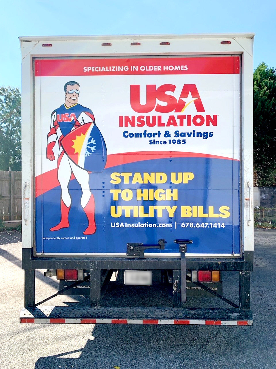 Close-up of high-quality vinyl installation on the Isuzu box truck commercial wrap.