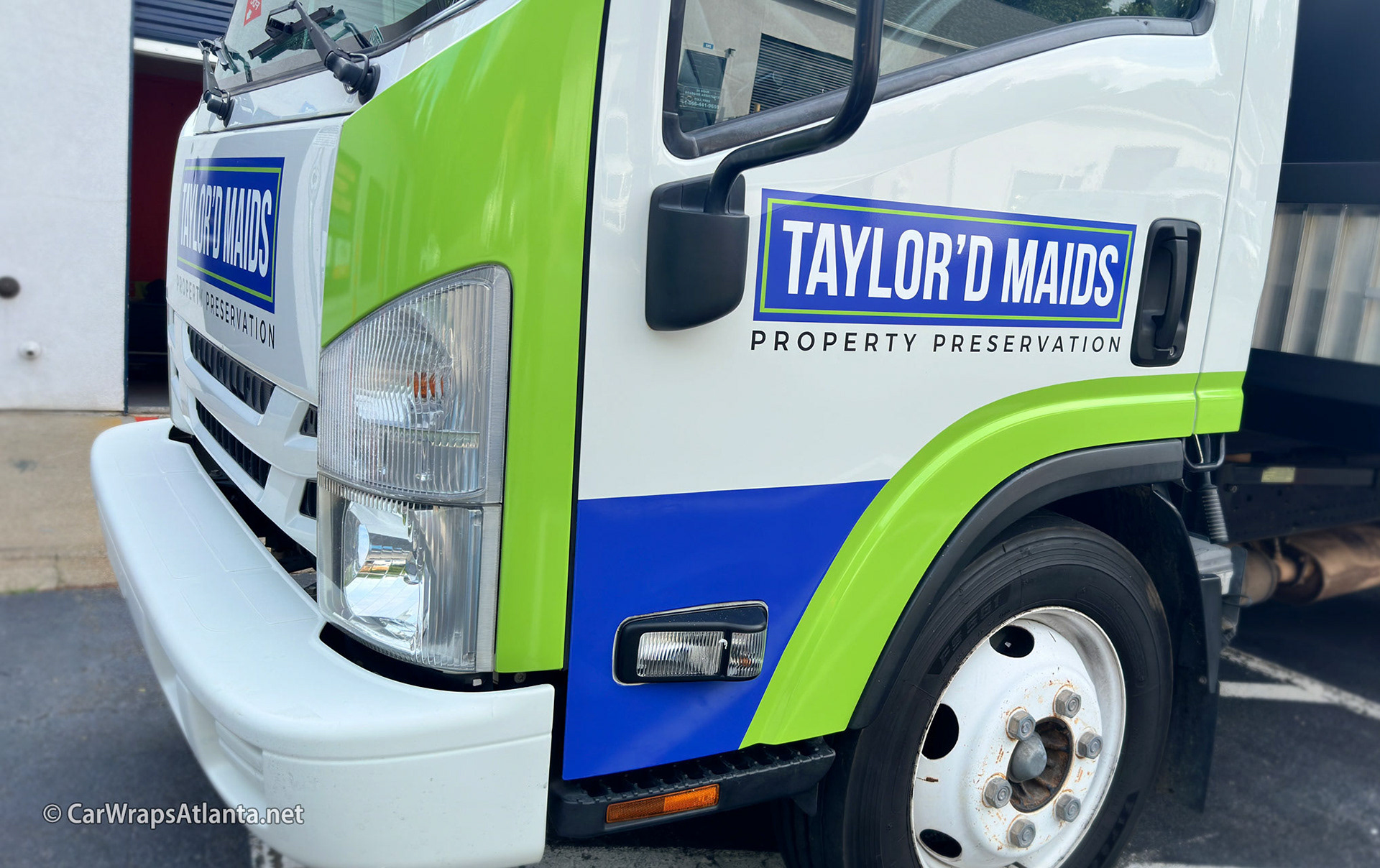 Side view of the full Isuzu Dump Trailer wrap demonstrating durable vinyl quality.