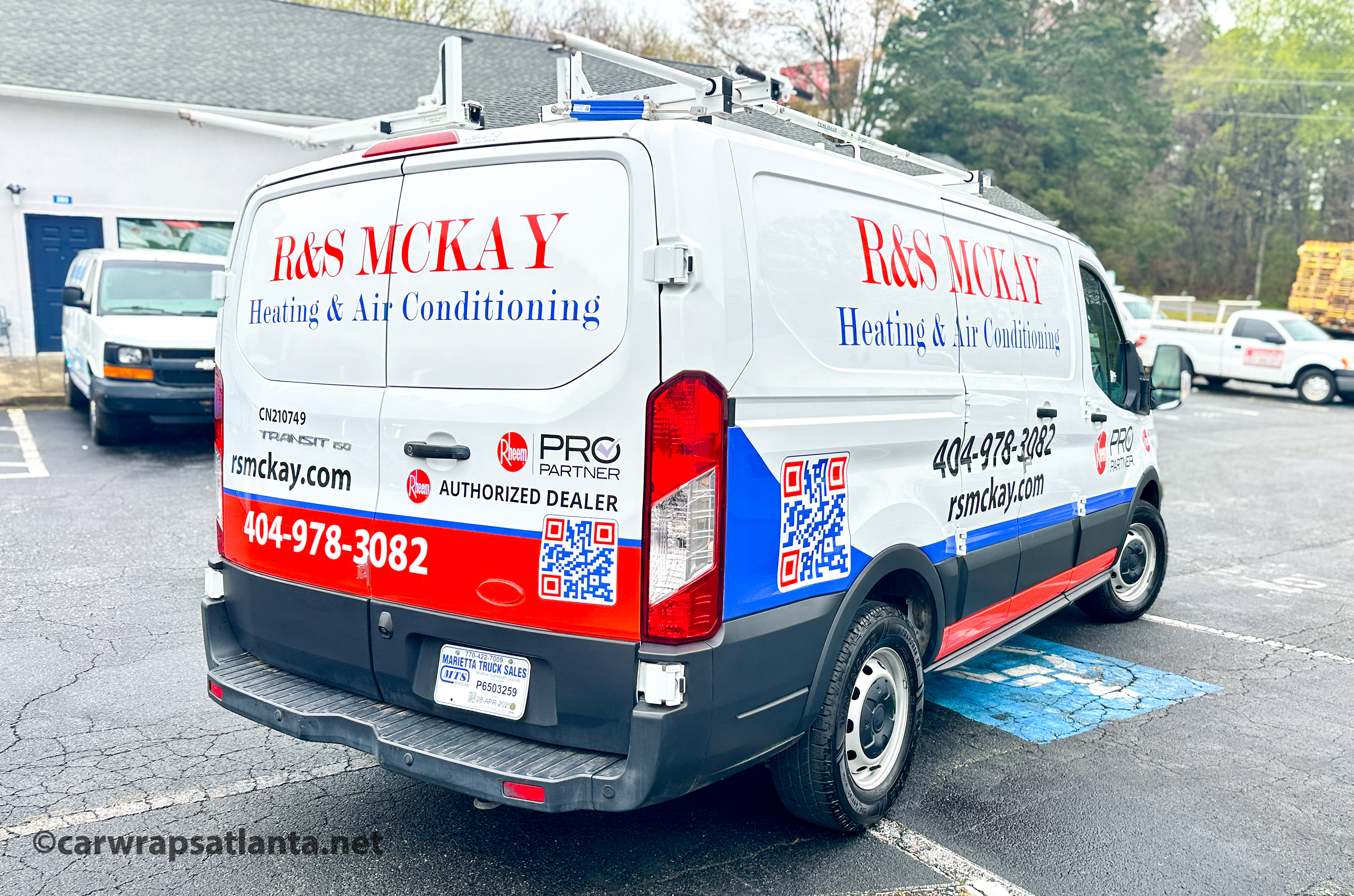 Side view of the Ford Transit partial wrap demonstrating high legibility and service visibility in Lawrenceville.