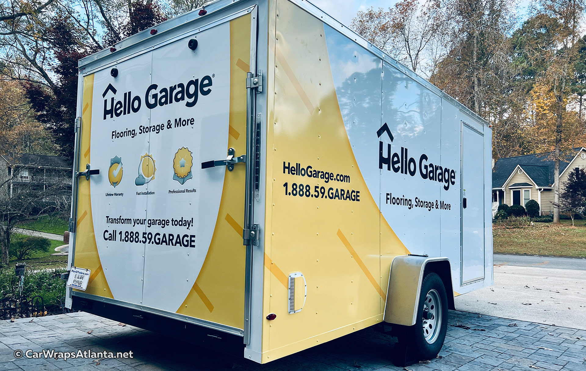 Custom trailer wrap parked in an Atlanta neighborhood, demonstrating local visibility for Hello Garage.
