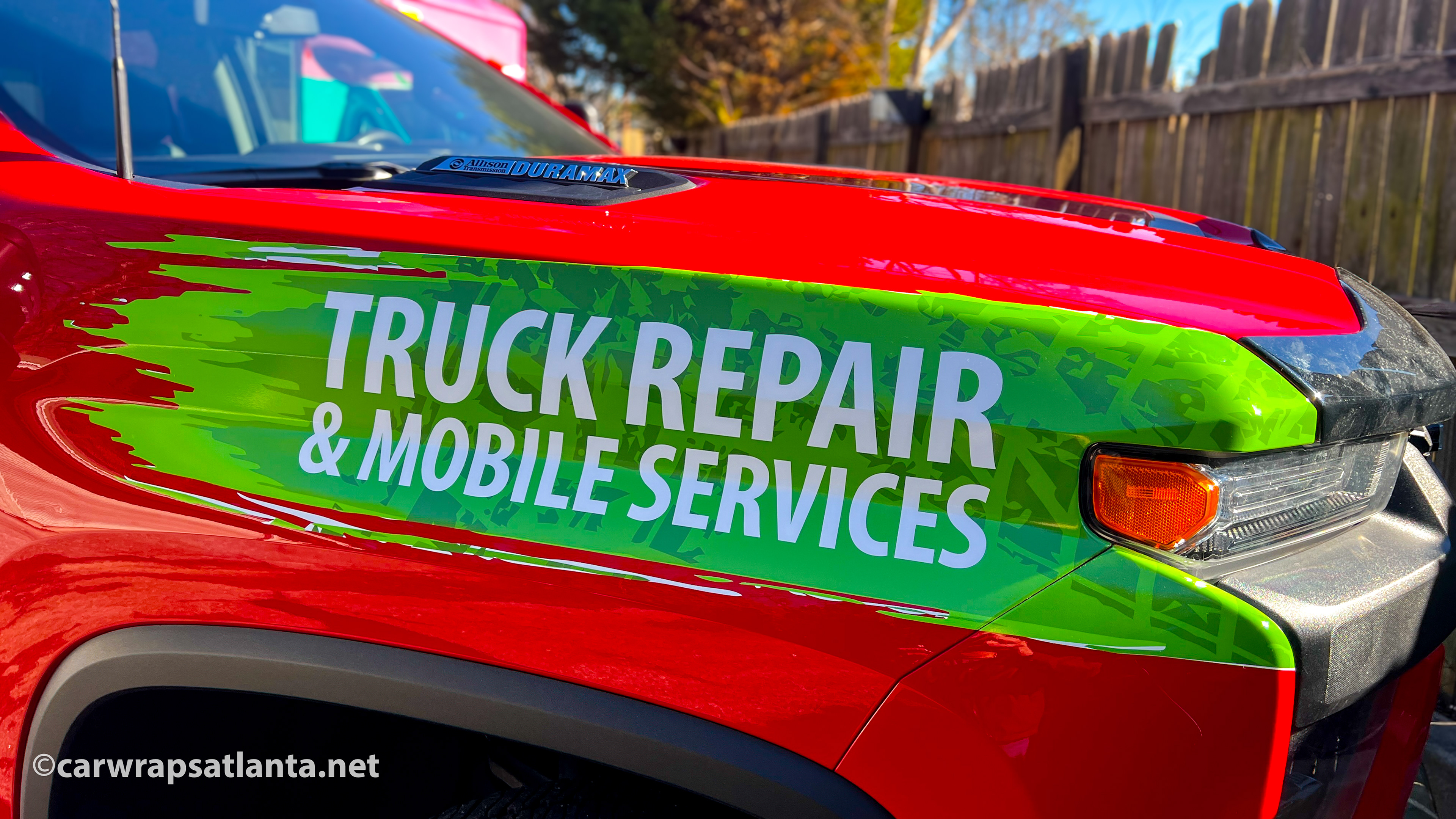 Side view of the Chevrolet 3500 HD partial wrap demonstrating effective service advertisement.