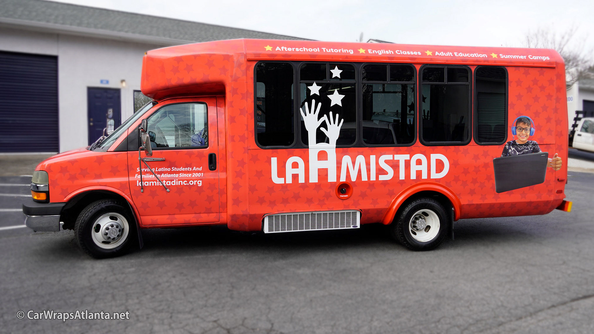 Vibrant full vehicle wrap on a school activity bus for the non-profit organization La Amistad in Atlanta.