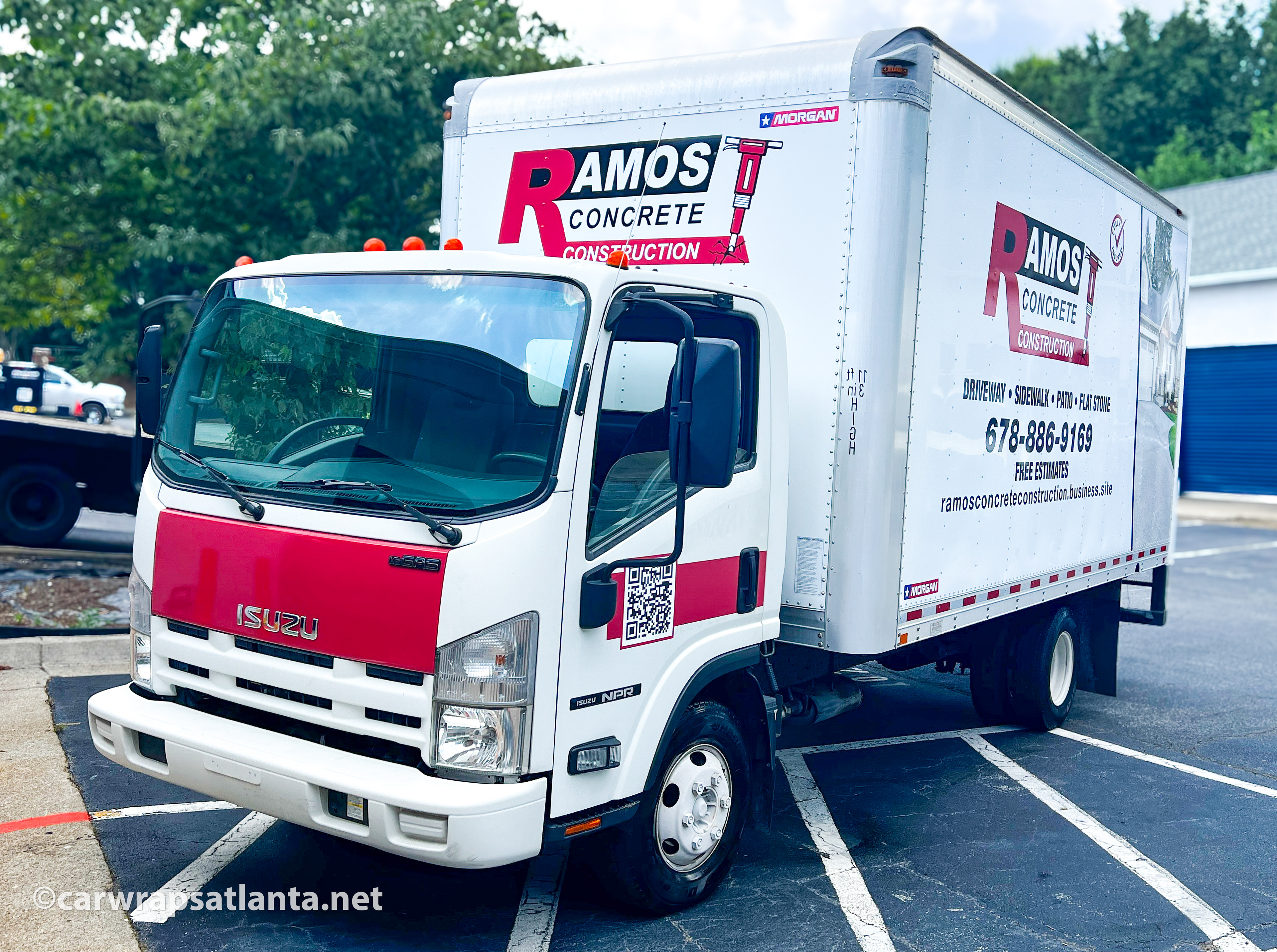 Close-up of the professional logo and key service details on the Isuzu Box Truck partial wrap.