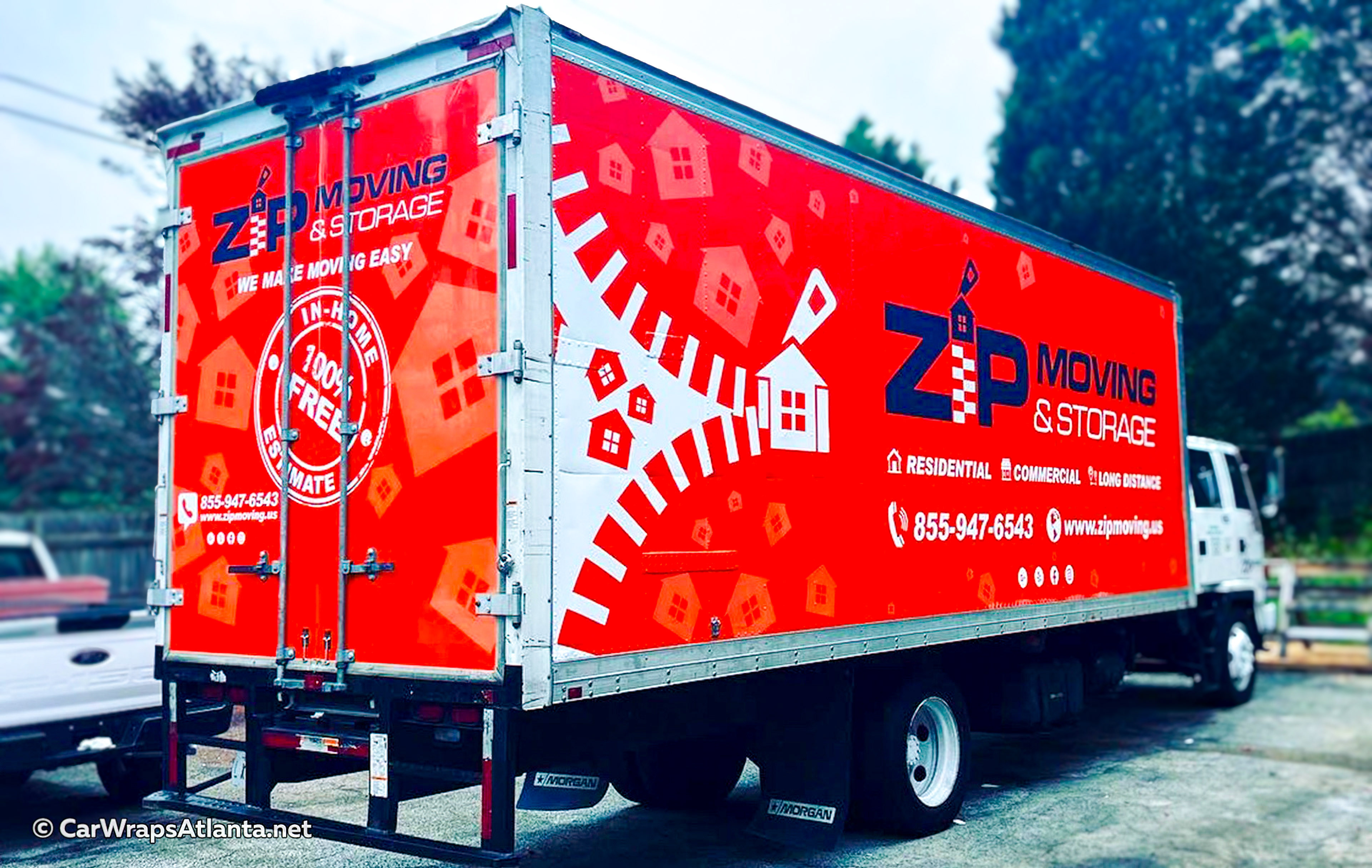 Full side view of the custom wrapped box truck demonstrating high visibility for the moving company fleet.