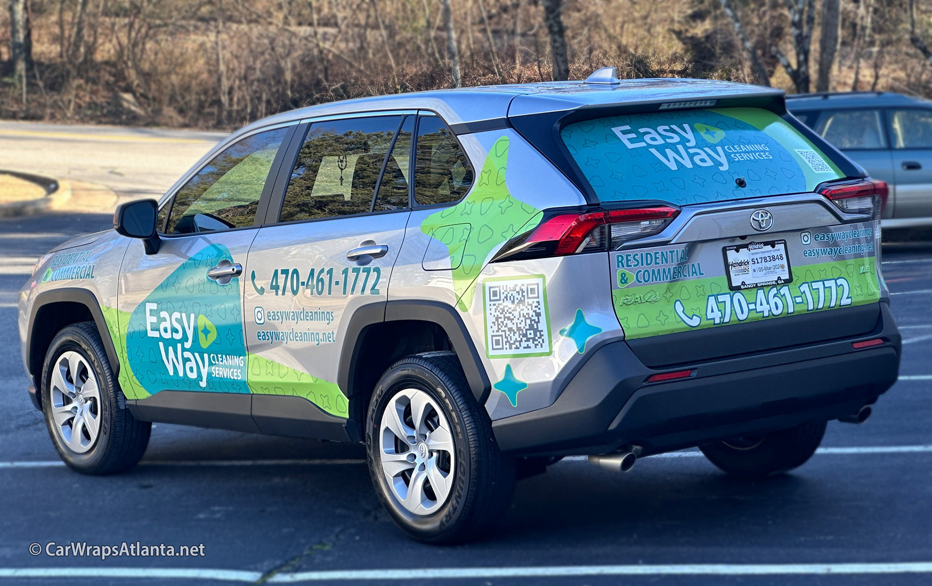 Toyota RAV4 with spot graphics showcasing professional cleaning service branding in an Atlanta neighborhood.