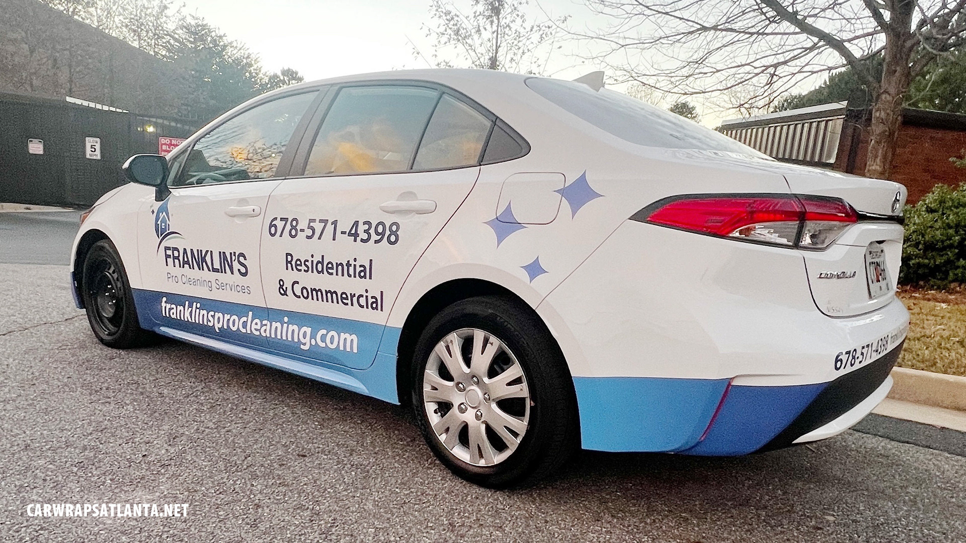Close-up of cleaning service logo and branding elements on the Toyota Corolla partial wrap.
