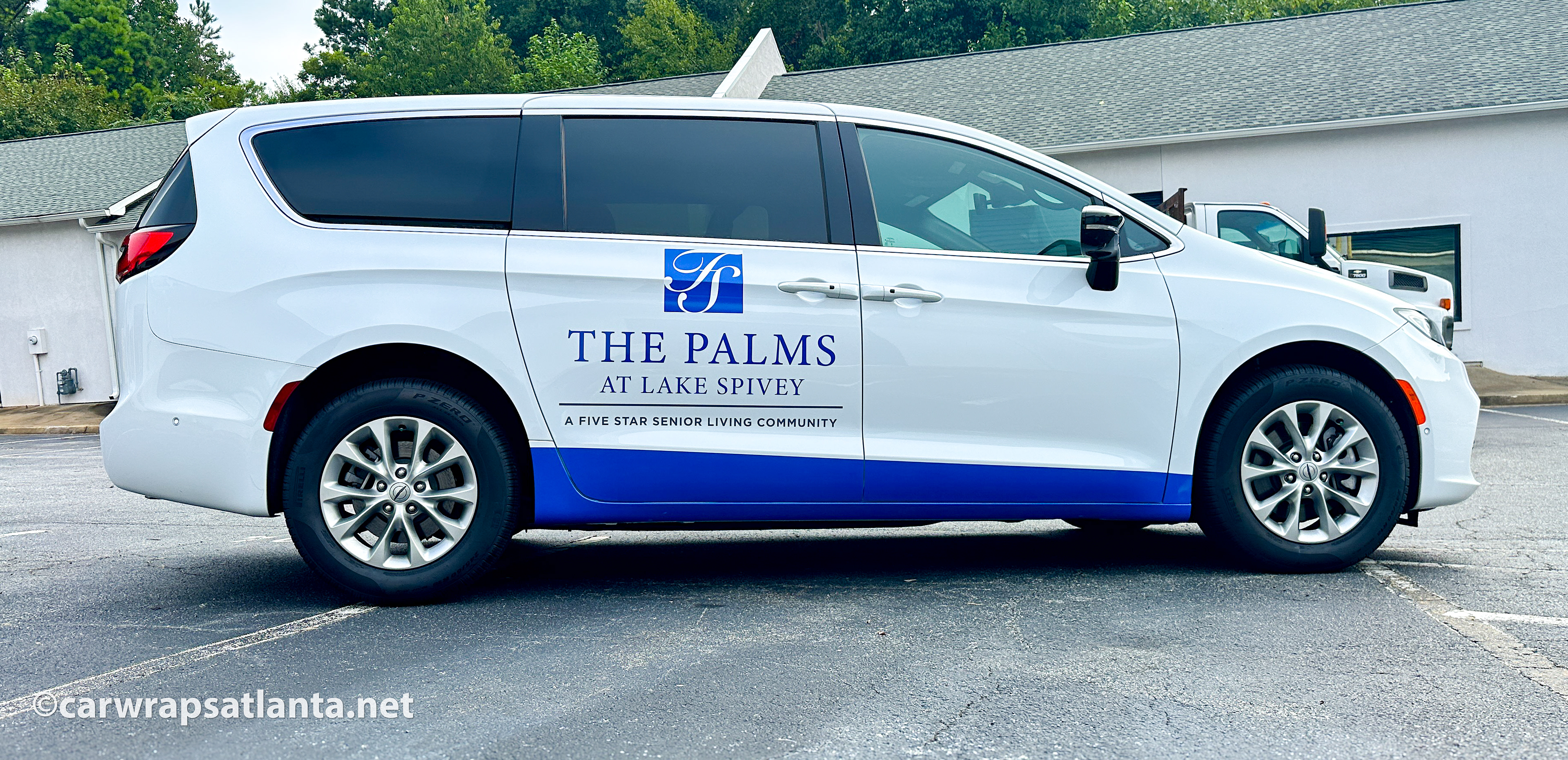 Close-up of the Senior Living Community logo and contact details on the Chrysler Pacifica spot graphics.