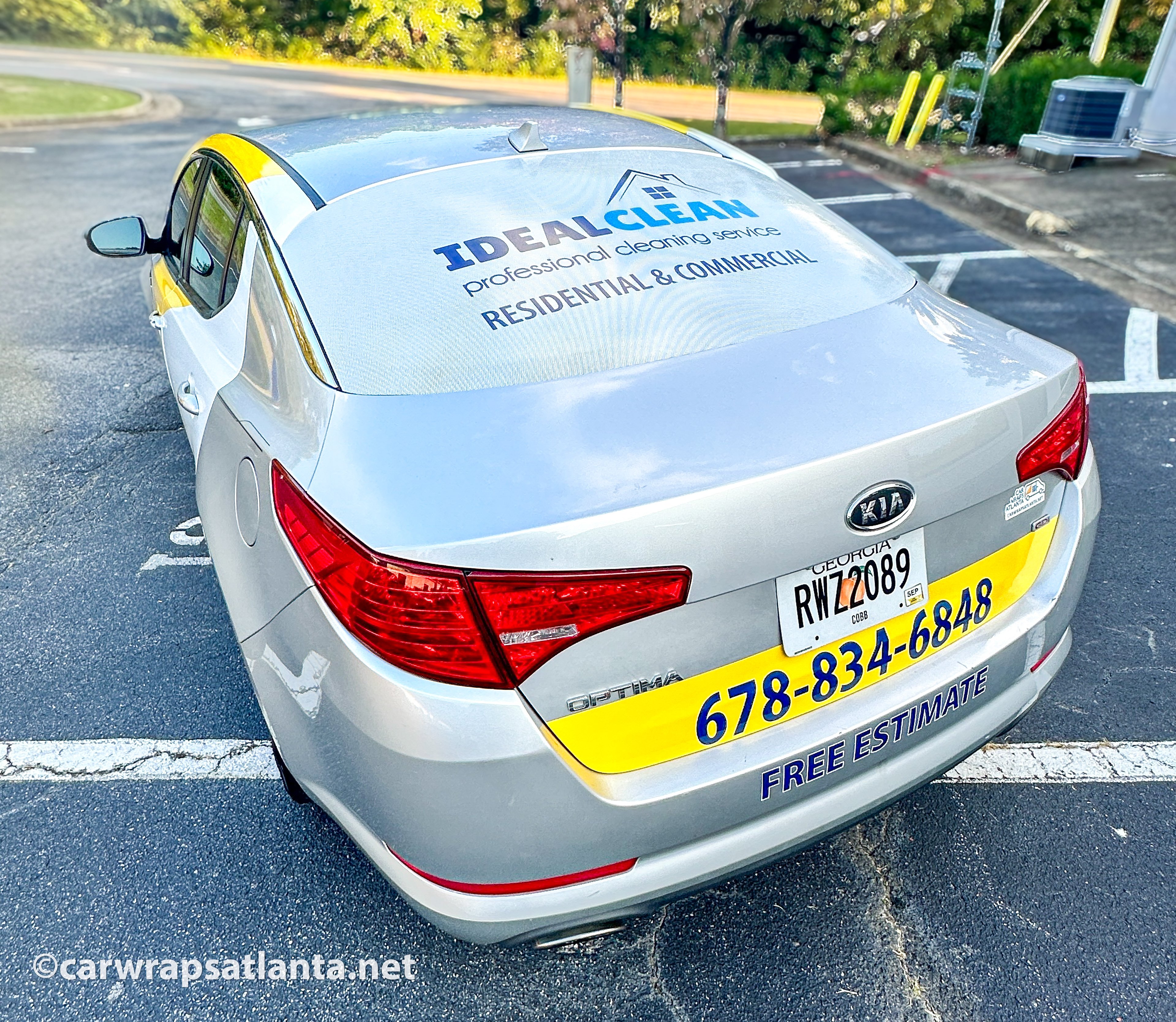 Rear view of the Kia Optima spot graphics emphasizing contact information for the cleaning service company.