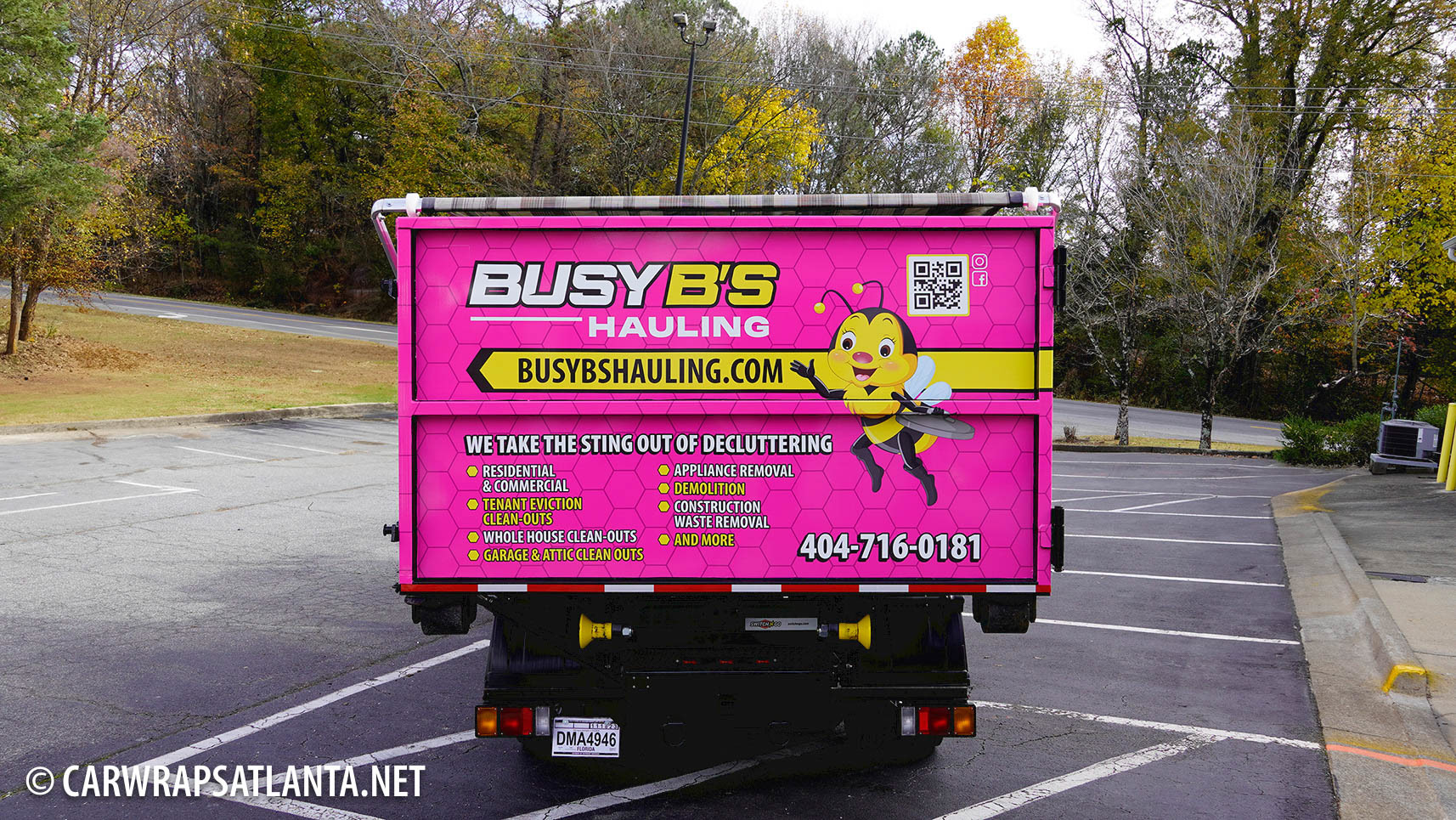 Rear view of the wrapped Isuzu Hauling Truck emphasizing contact information visibility.