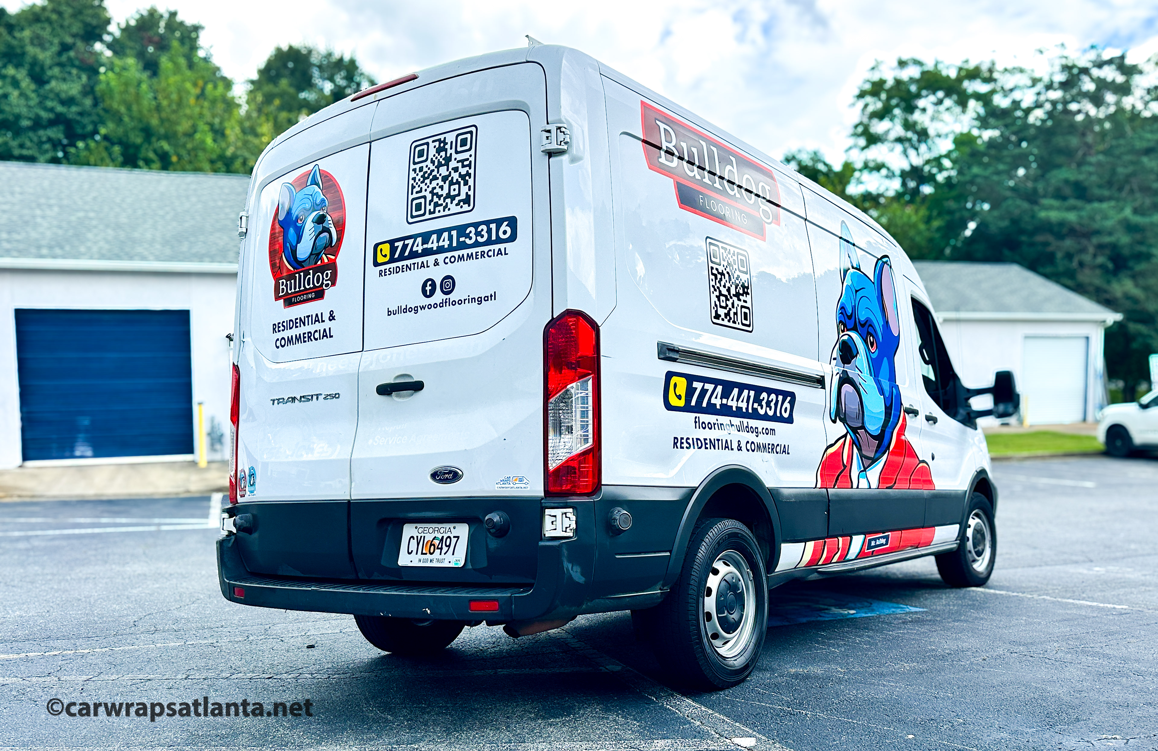 Rear view of the wrapped Ford Transit showcasing service list and contact information for the flooring company.