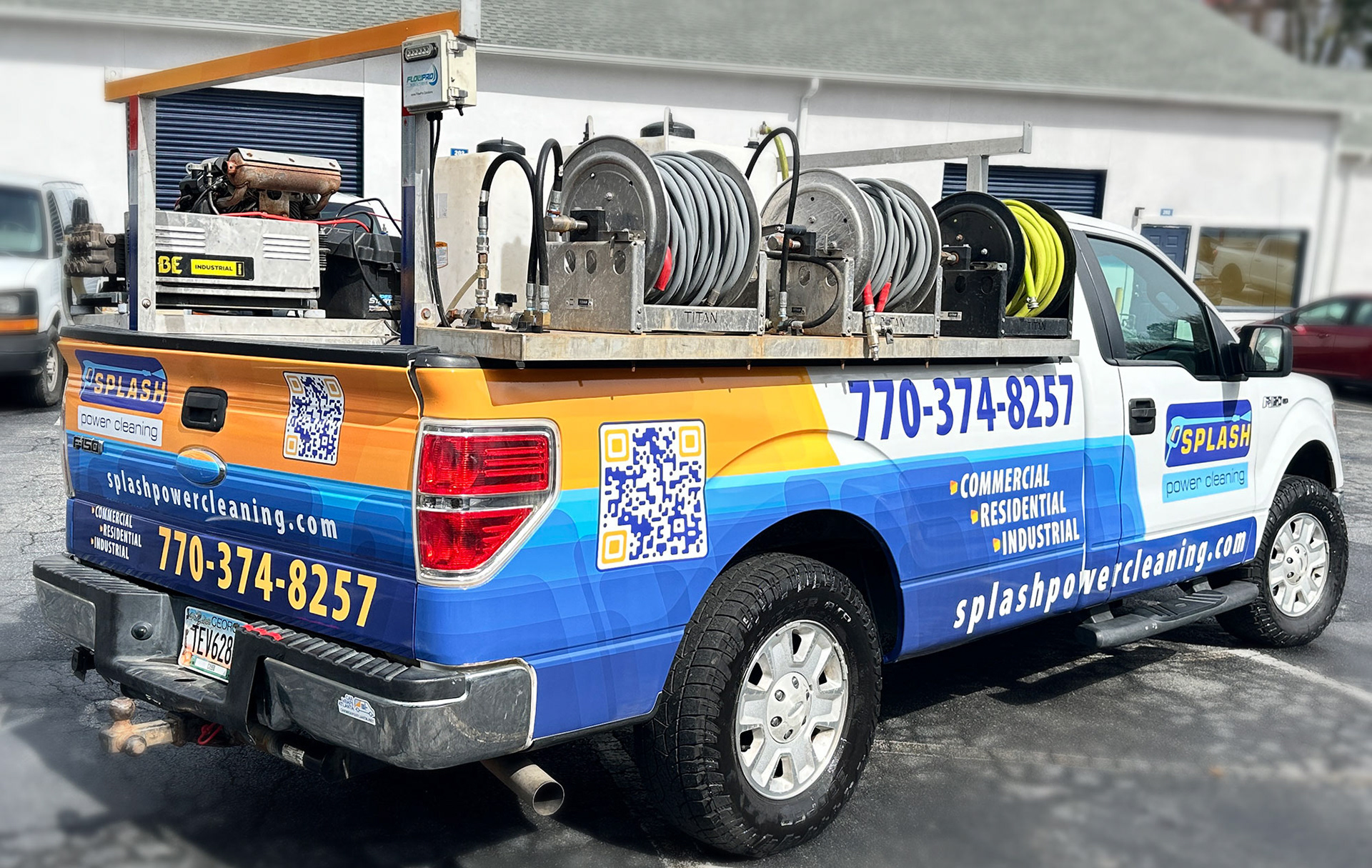 Wrapped Ford F-150 driving through Atlanta with professional fleet graphics for mobile advertising