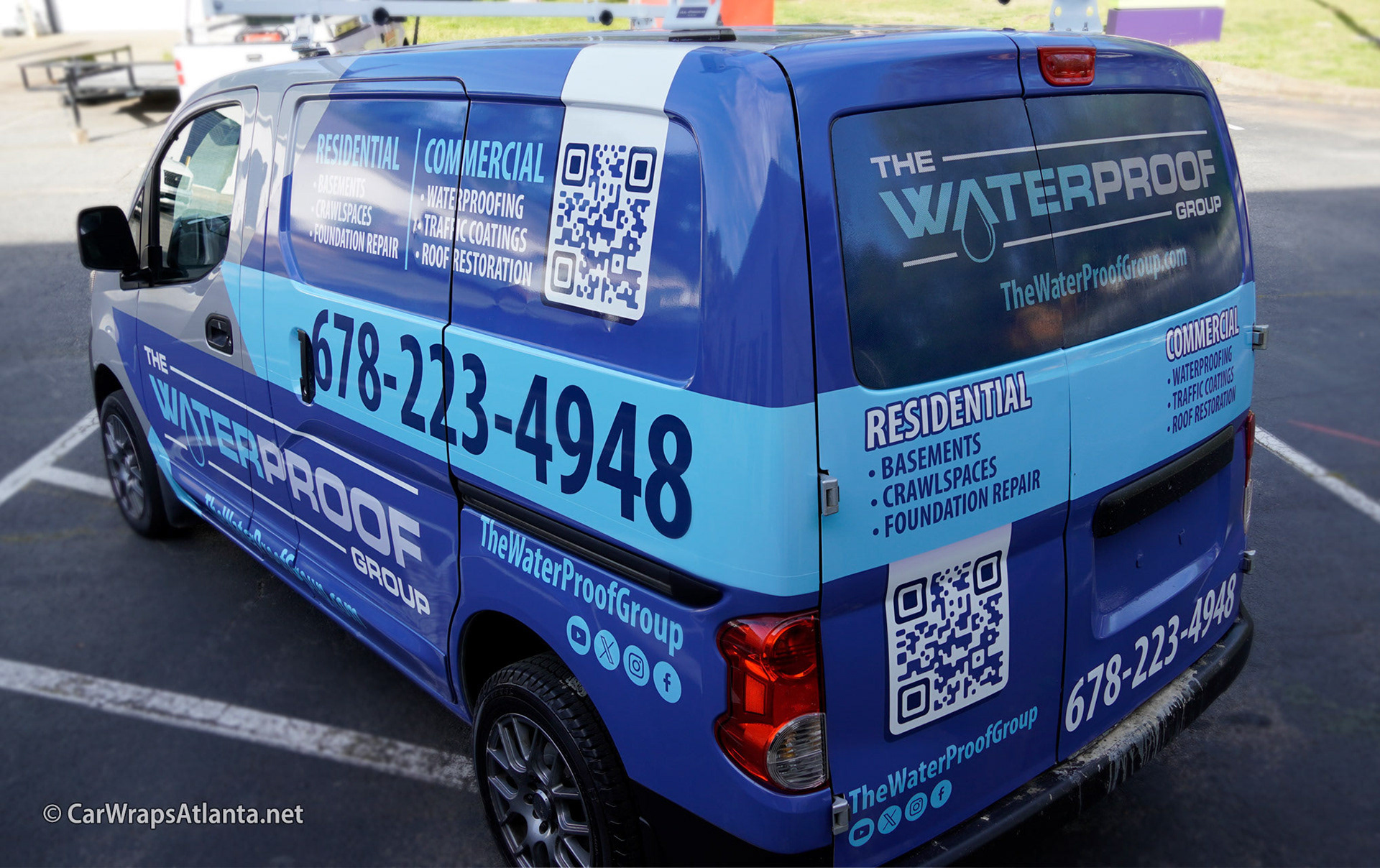 Rear door graphics on the Nissan NV200 partial wrap displaying waterproofing service information.