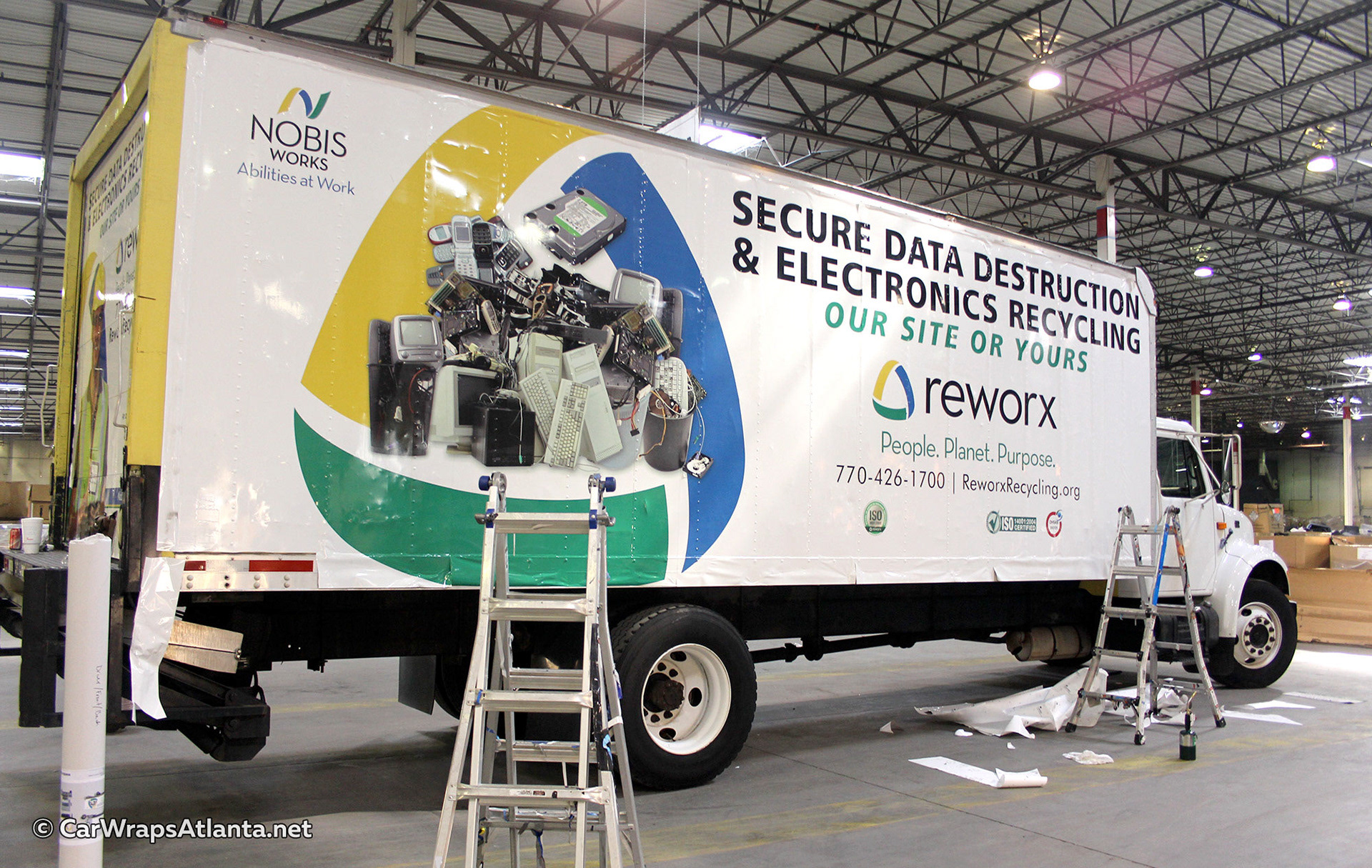 Close-up of eco-friendly messaging and logo on the full recycling box truck wrap.