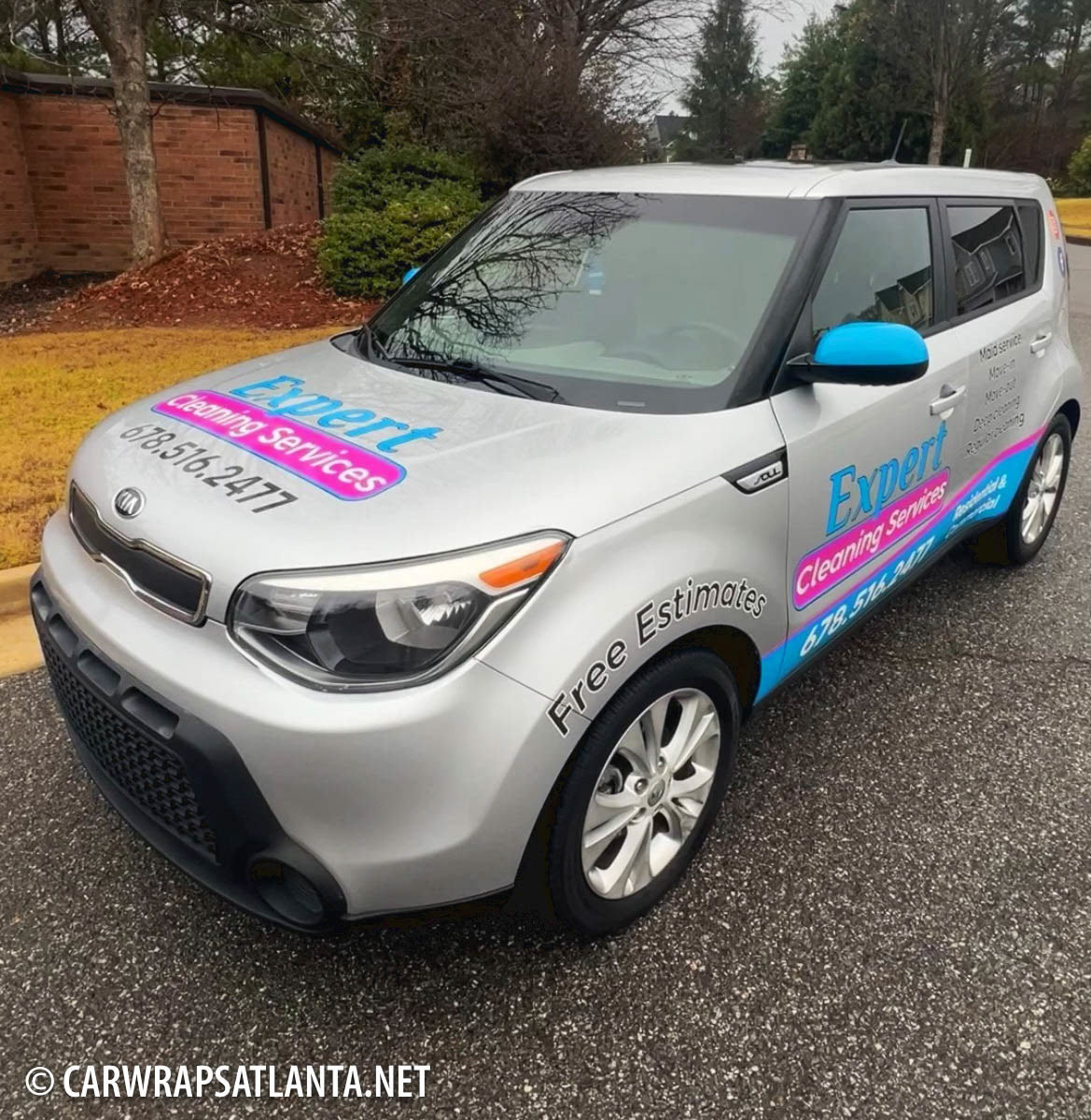 Close-up of cleaning service logo and vibrant graphics on the Kia Soul partial wrap.