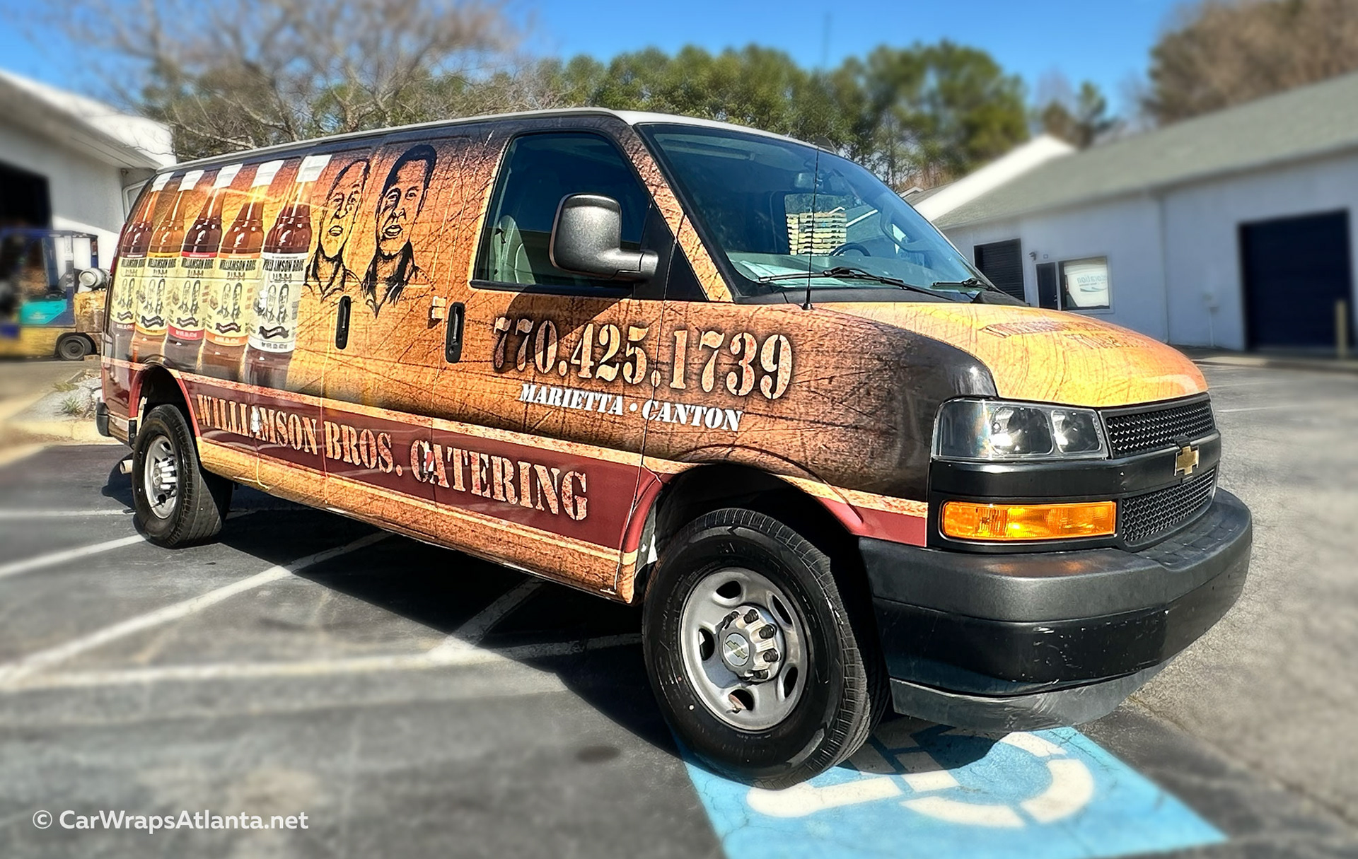 Atlanta-based vehicle wrap on Williamson Bros Bar-B-Q van, displaying full coverage fleet graphics with restaurant branding, vivid imagery, and professional vinyl wrap installation.