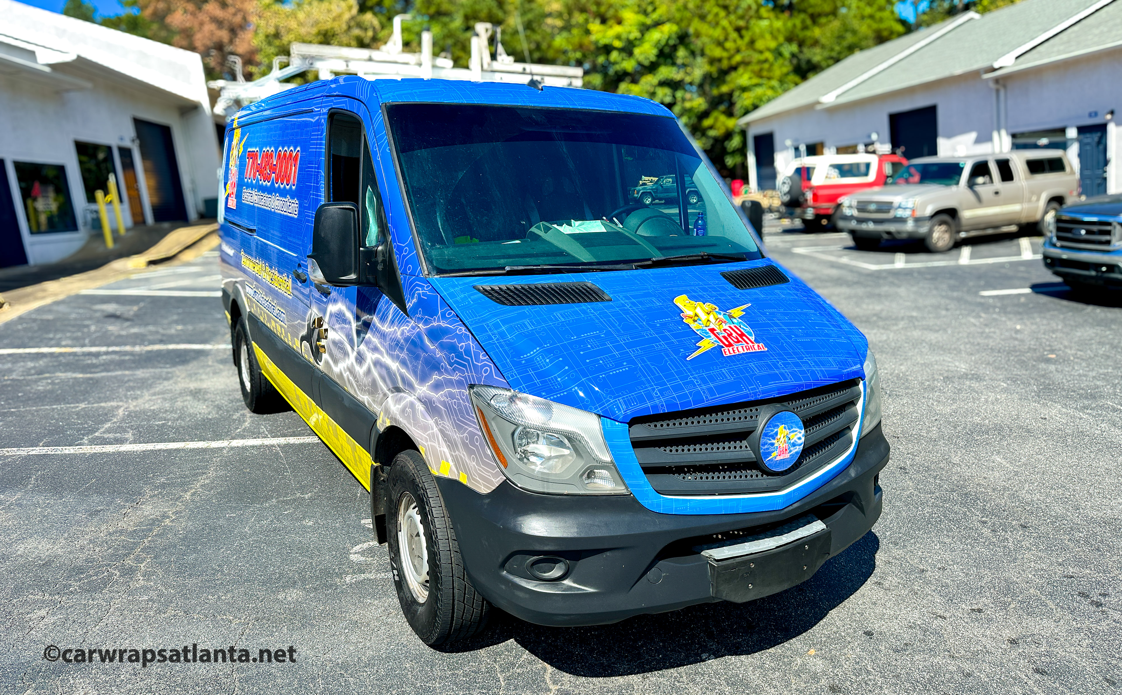 In-progress photo showing the meticulous installation of the full wrap on the Mercedes-Benz Sprinter van.