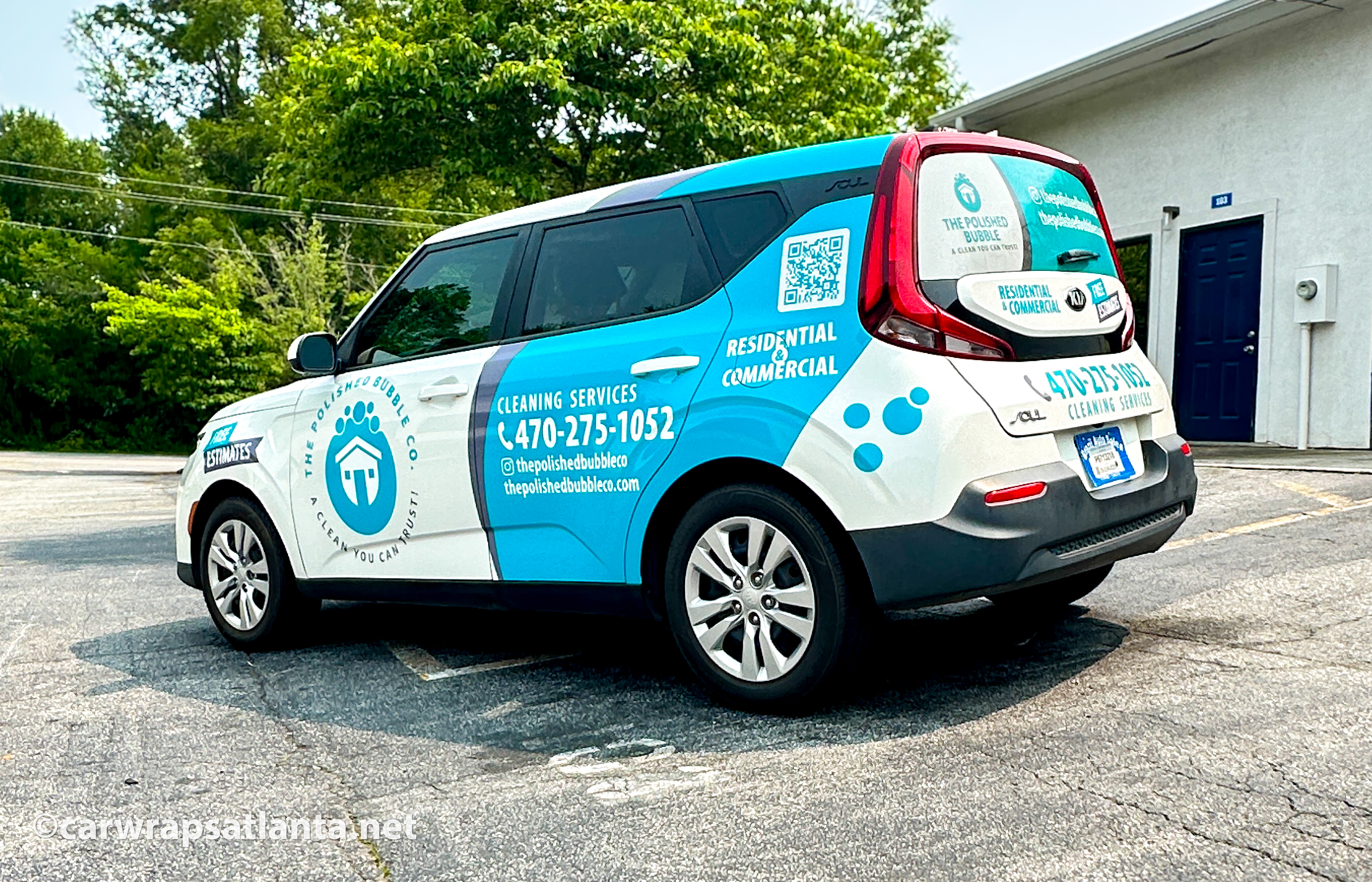 Close-up of the cleaning company logo and graphics on the partial wrap of the Kia Soul SUV.