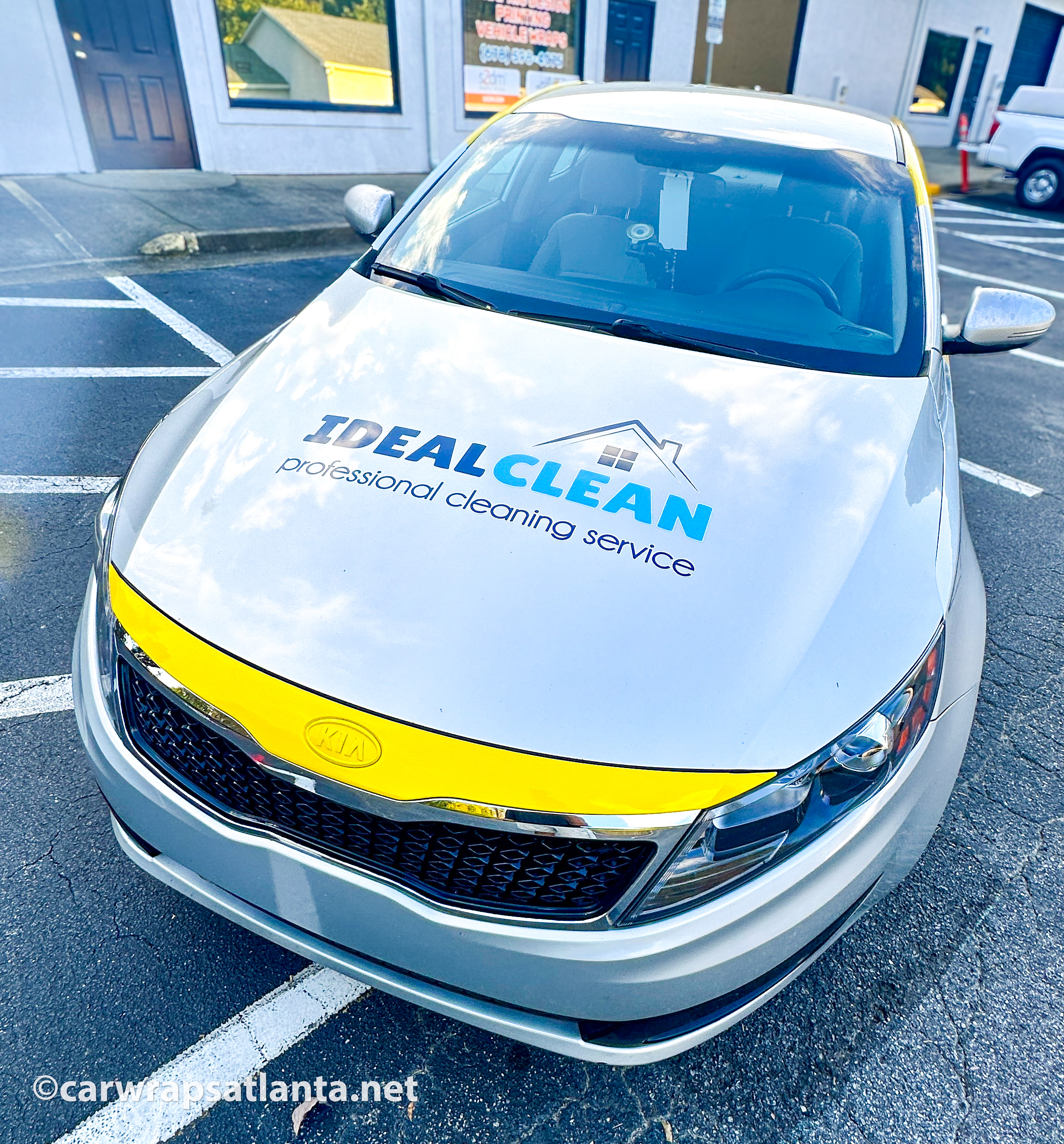 Front view of the Kia Optima showing strategic placement of spot graphics on the doors and rear window.