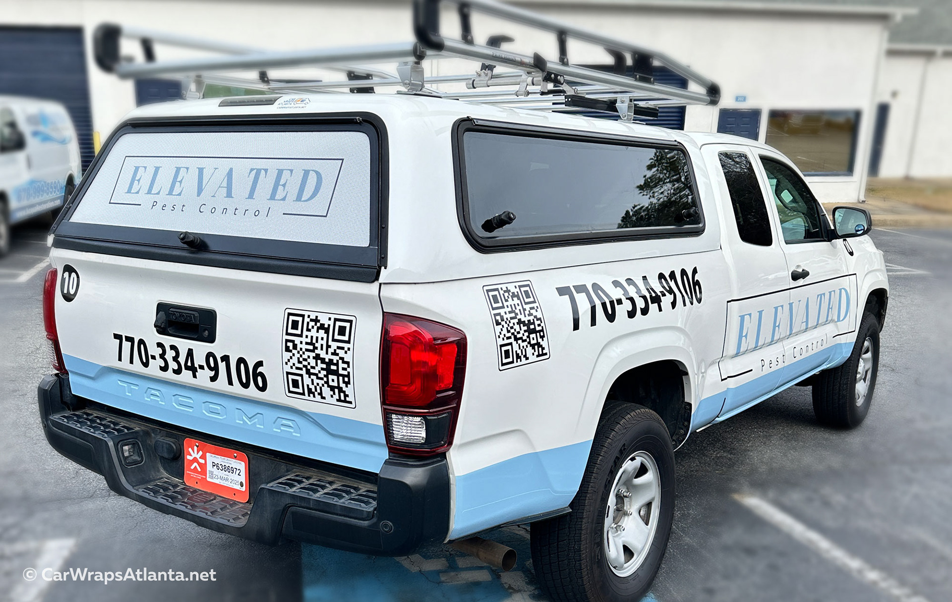 Custom vinyl vehicle graphics on a Toyota Tacoma truck for a pest control company, showcasing Atlanta fleet branding.