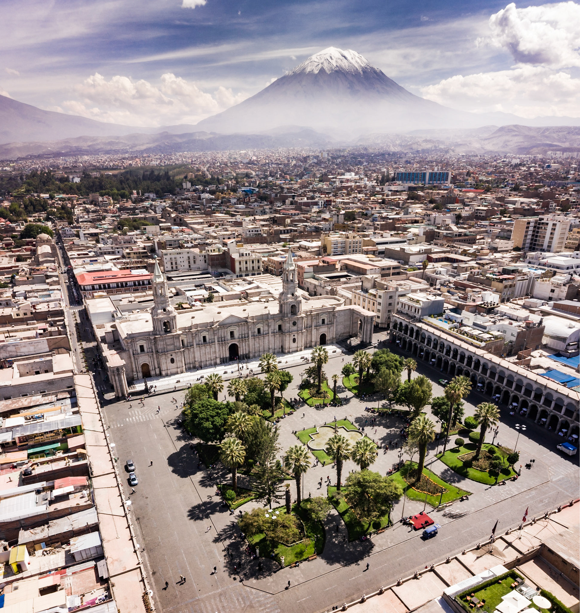Aerial drone view of Arequipa main square and cathedral church, with the Misti volcano as background.