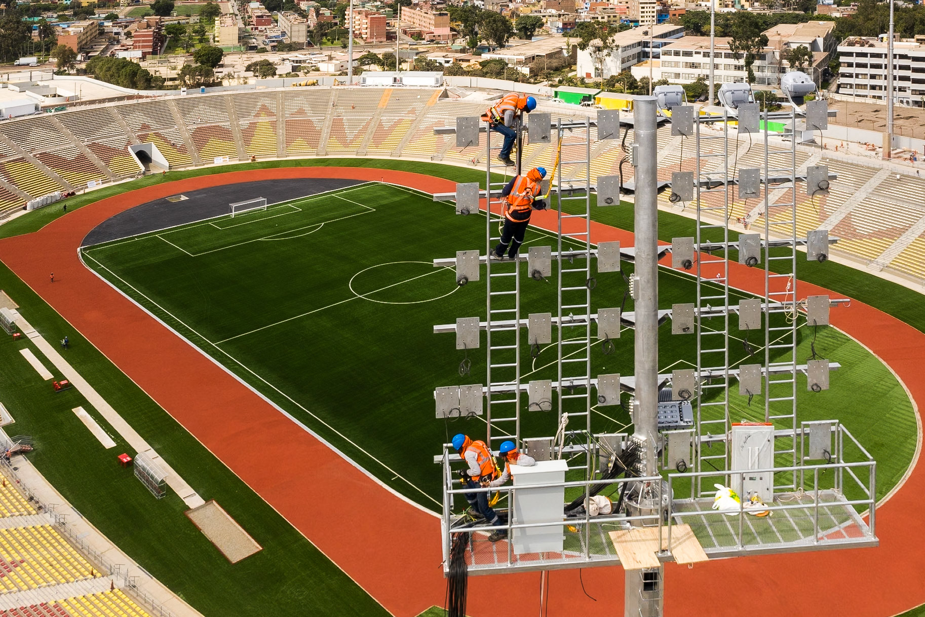 LIMA, PERU - CIRCA 2019: A group of men work in the light tower of San Marcos Stadium circa 2019, in Lima, Peru.