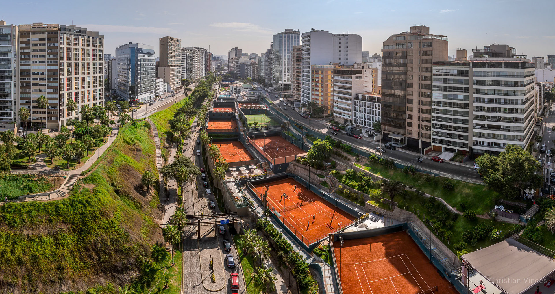 Panoramic aerial image of the heart of Miraflores, showing the buildings and a tennis club on the Bajada Balta in Lima, Peru.