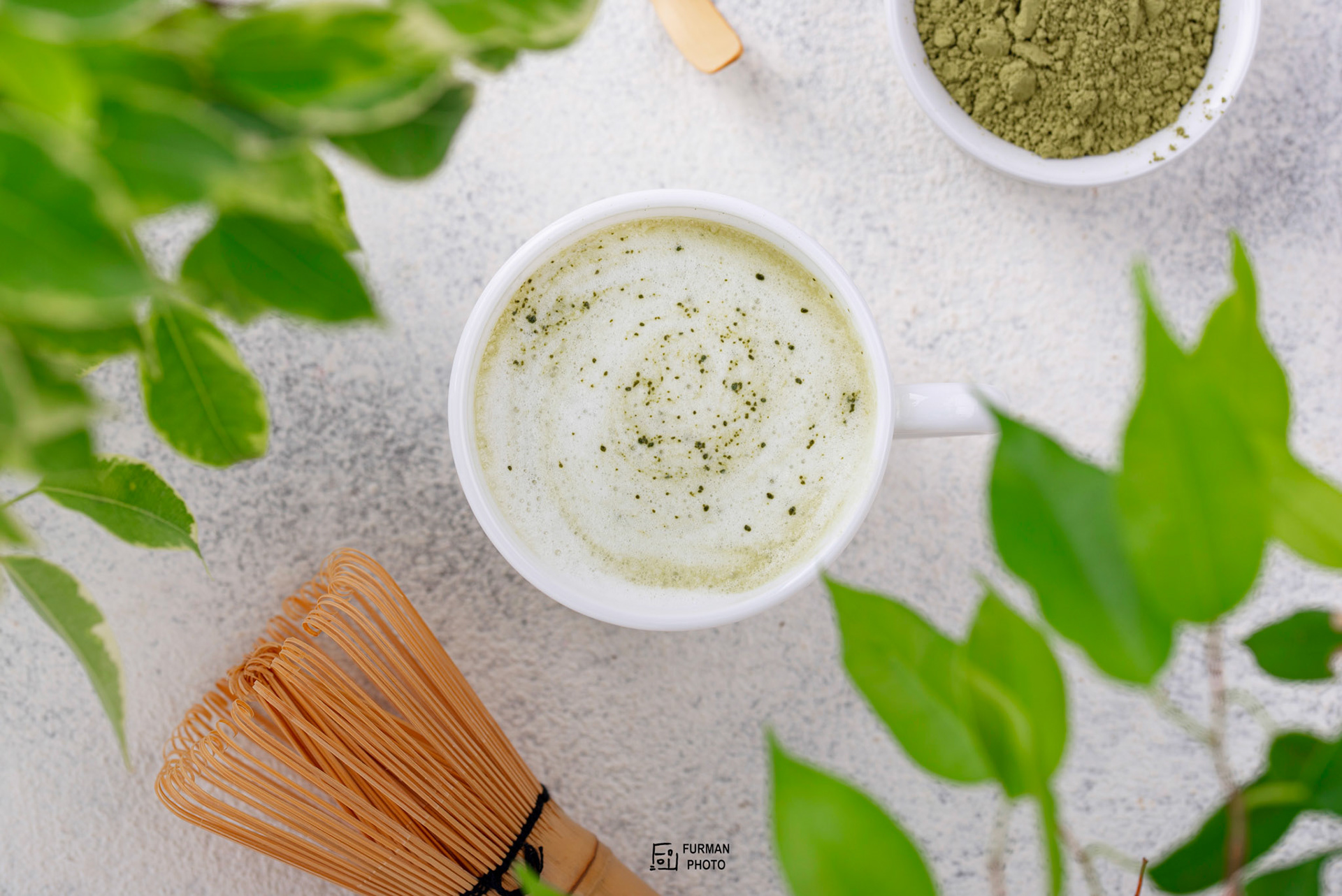 Green healthy matcha latte drink and bamboo tools for prepared
