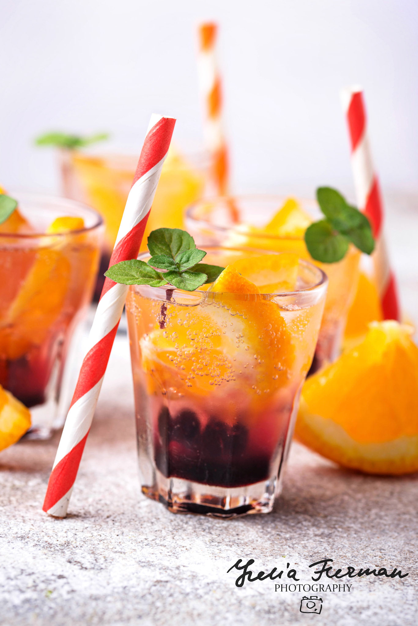 Summer fresh cold drink with orange and berries. Selective focus