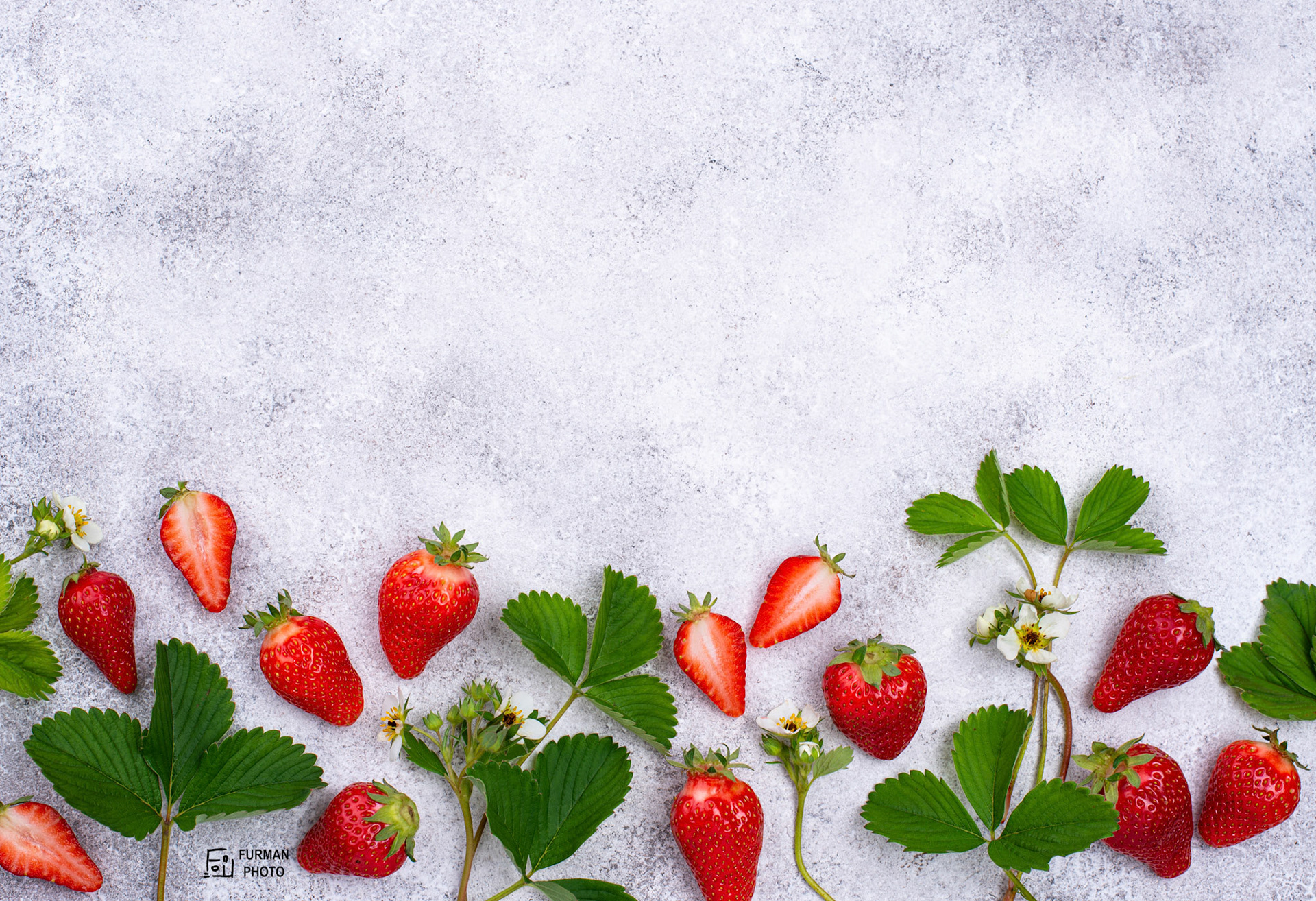 Fresh ripe strawberry with leaves and flowers. Top view