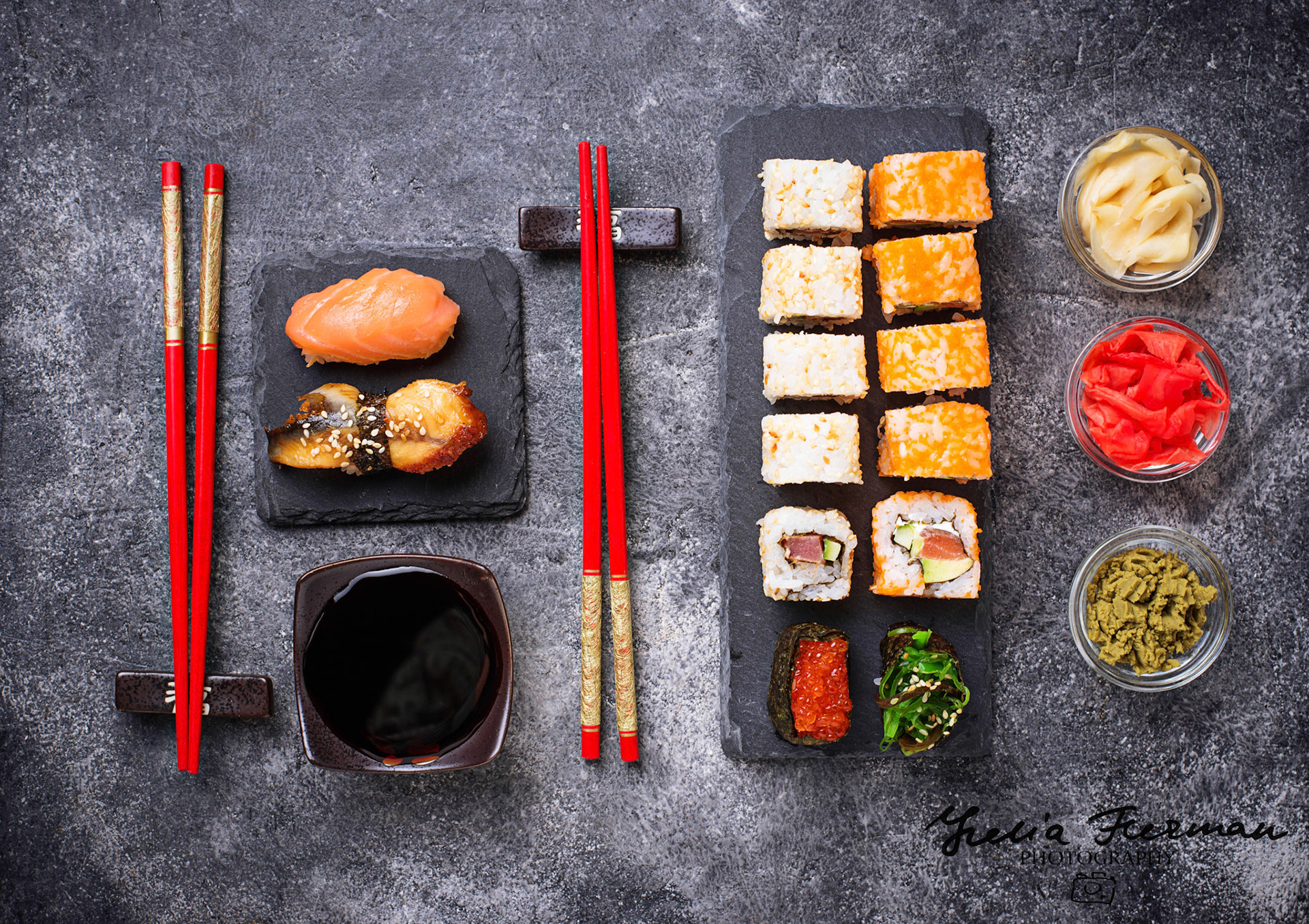 Sushi and roll set on black table. Top view