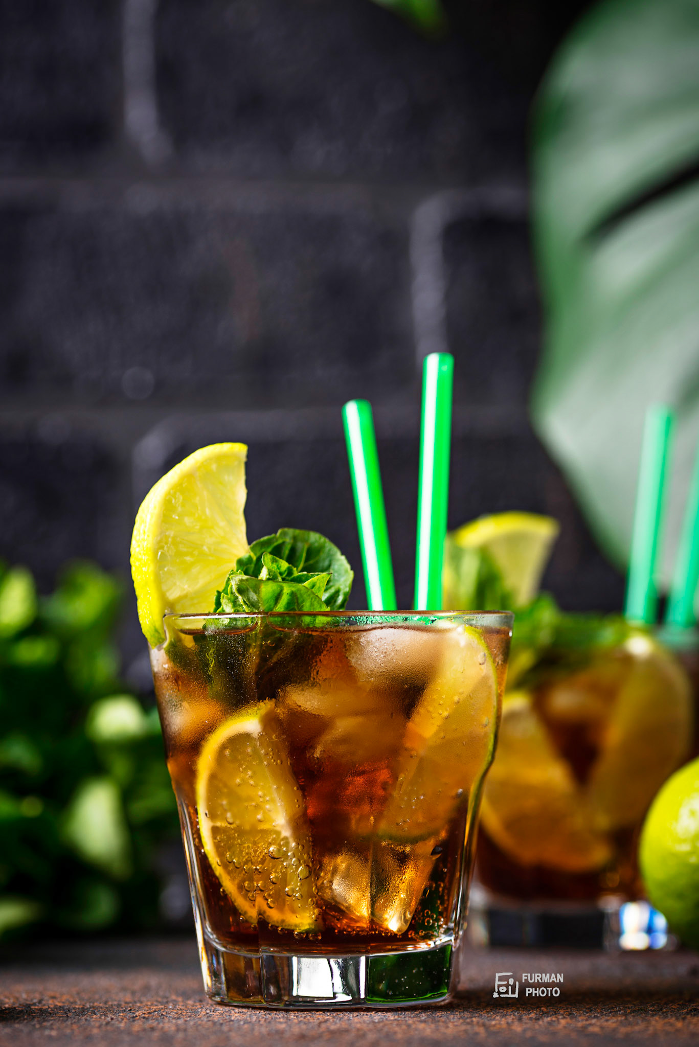 Cuba libre cocktail with mint, lime and ice
