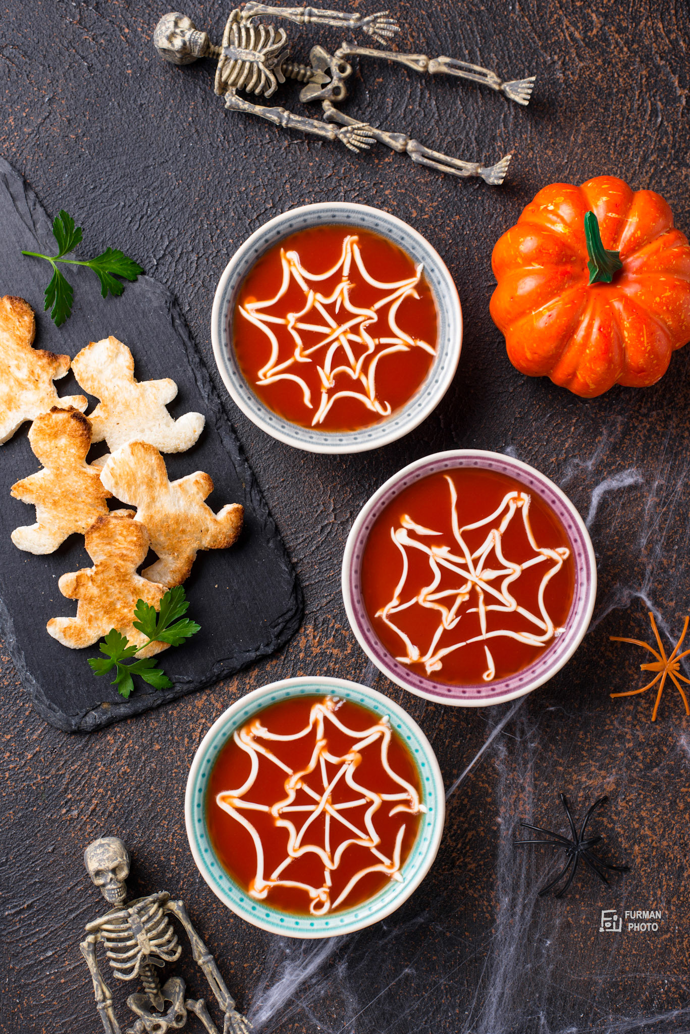 Tomato soup and bread in shape of men. Halloween treats for party.